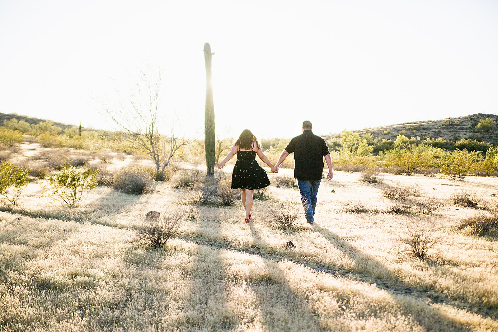 Couple walking together during their Thunderbird Mountain engagement session by Phoenix engagement photographer PMA Photography.