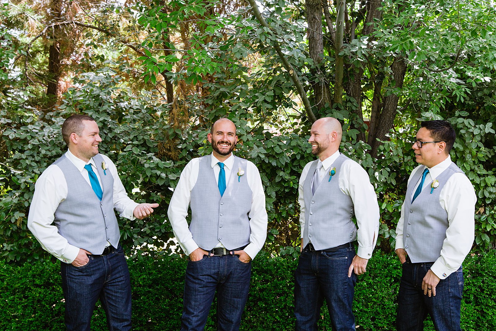 Groom and groomsmen laughing together at The Windmill House wedding by Chino Valley wedding photographer PMA Photography.