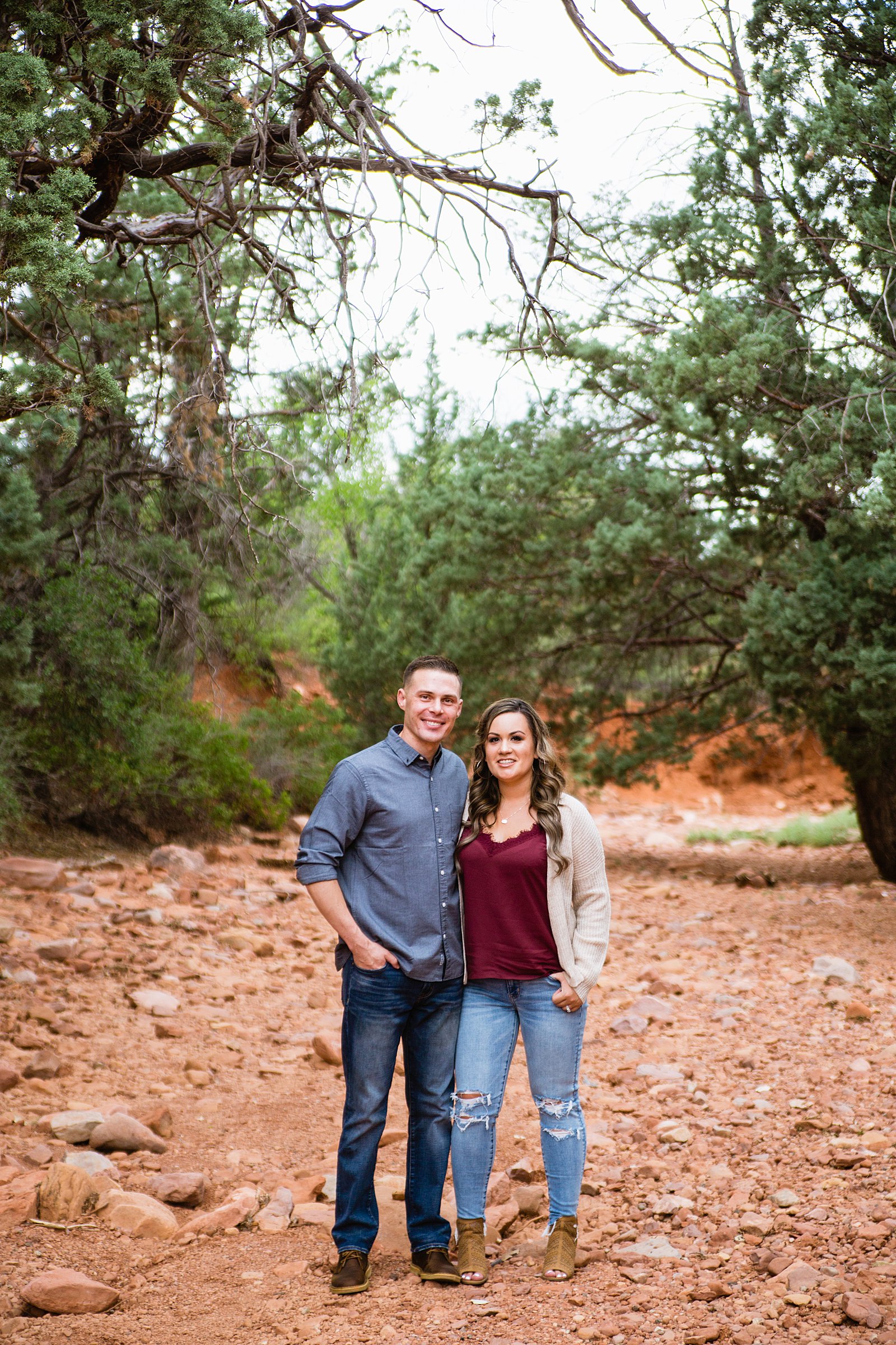 Couple pose for their Cathedral Rock engagement session by Sedona wedding photographer PMA Photography.