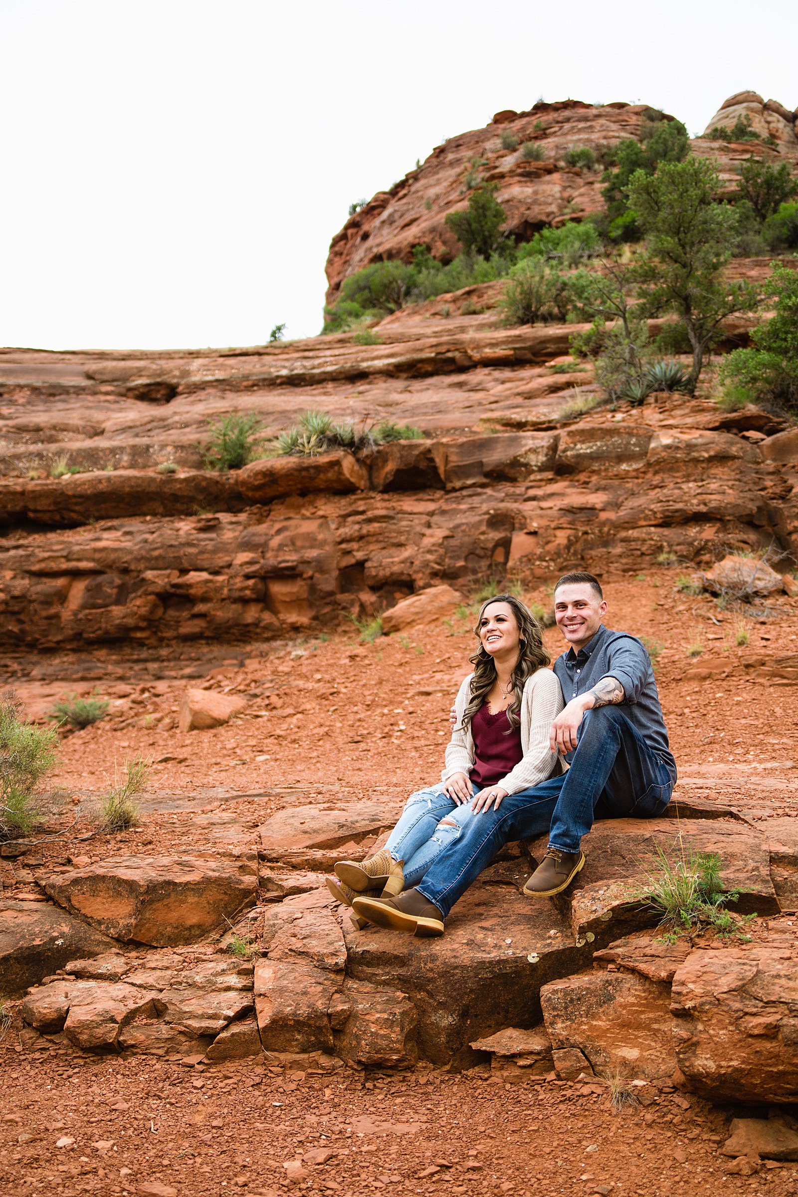 Couple pose for their Cathedral Rock engagement session by Sedona wedding photographer PMA Photography.