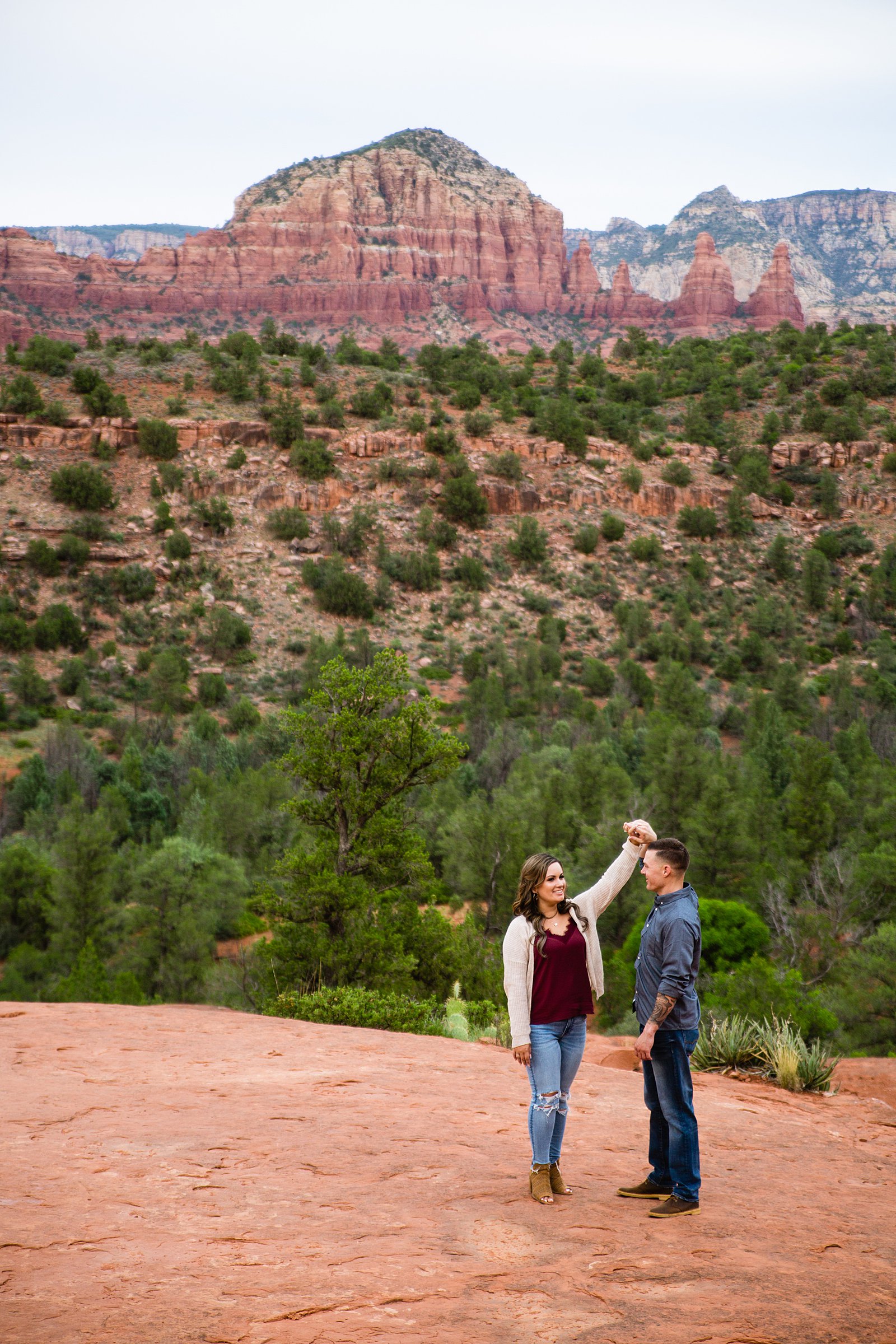 Couple pose during their Sedona engagement session by Arizona wedding photographer PMA Photography.