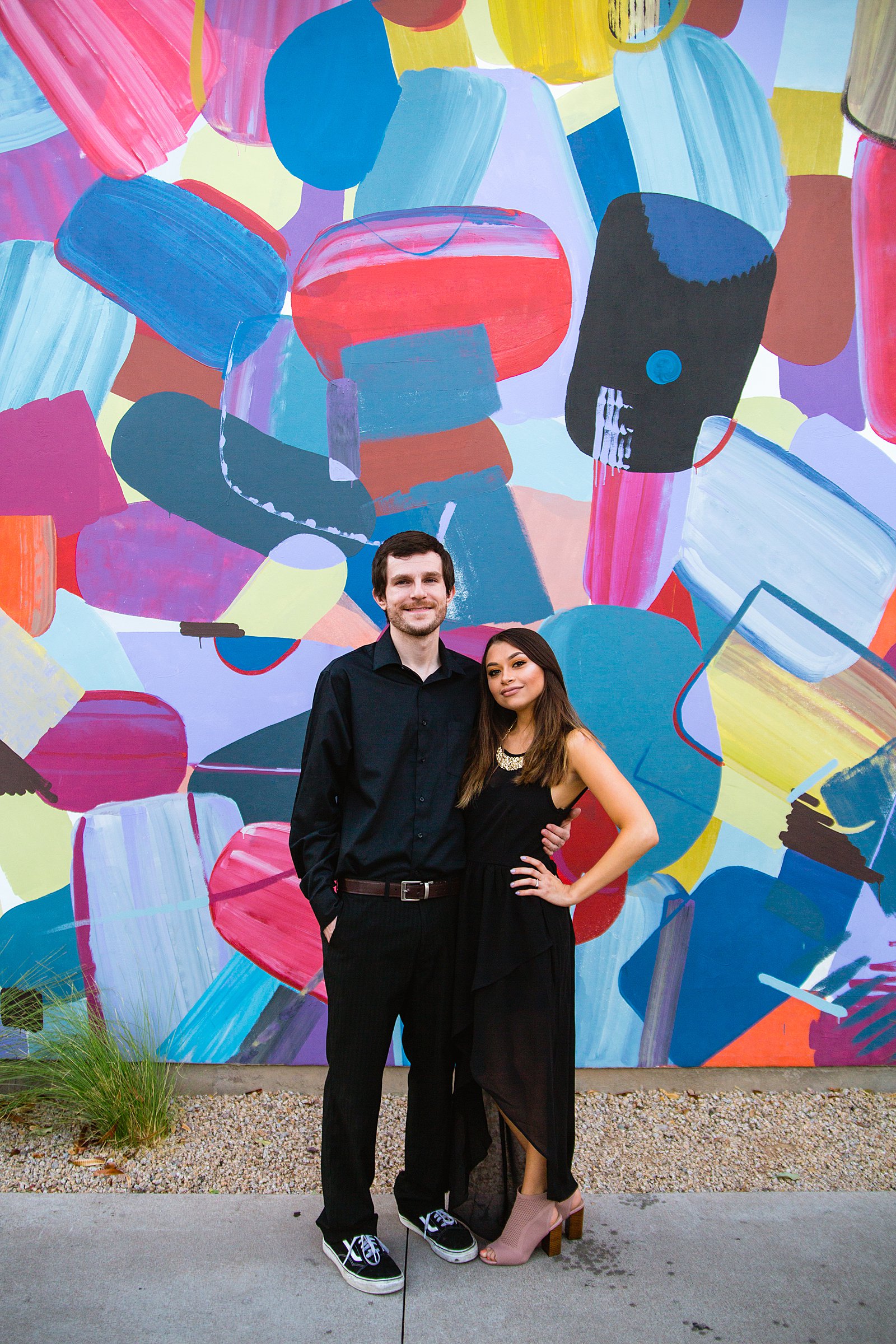 Couple pose for their Downtown Gilbert engagement session by Gilbert wedding photographer PMA Photography.