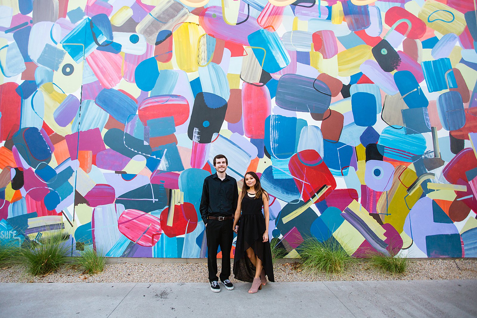 Couple pose for their Downtown Gilbert engagement session by Gilbert wedding photographer PMA Photography.