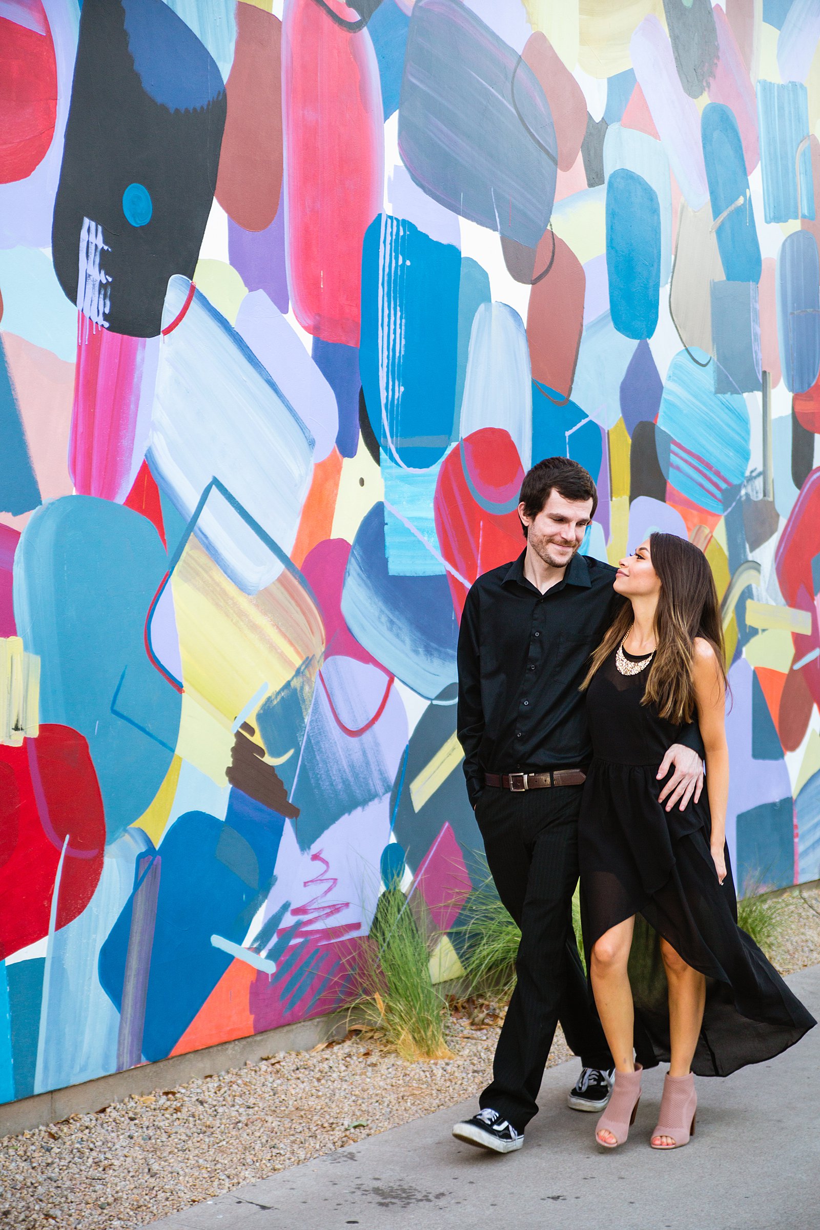 Couple walking together during their Downtown Gilbert engagement session by Gilbert engagement photographer PMA Photography.