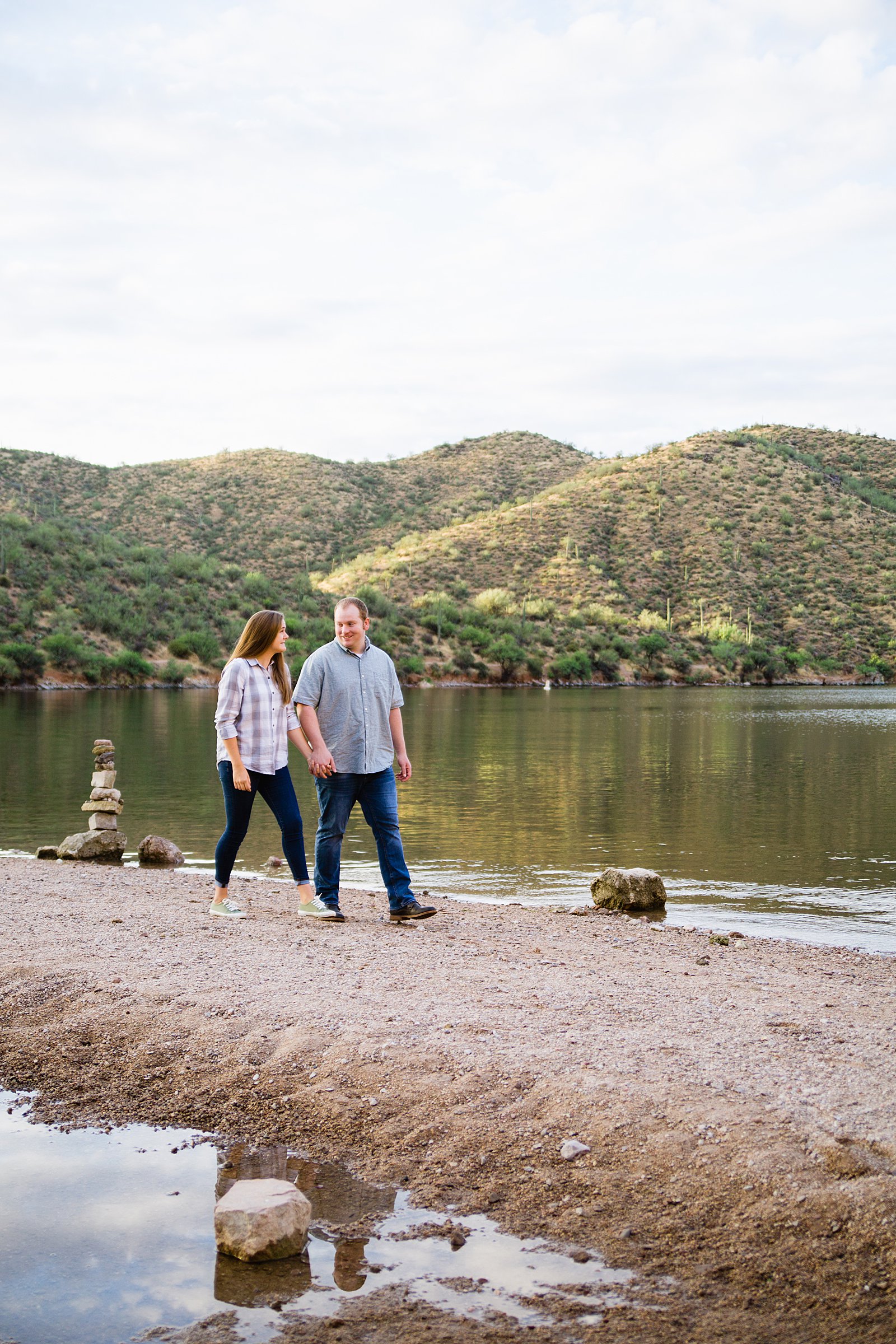 Couple walking together during their Saguaro Lake engagement session by Phoenix engagement photographer PMA Photography.