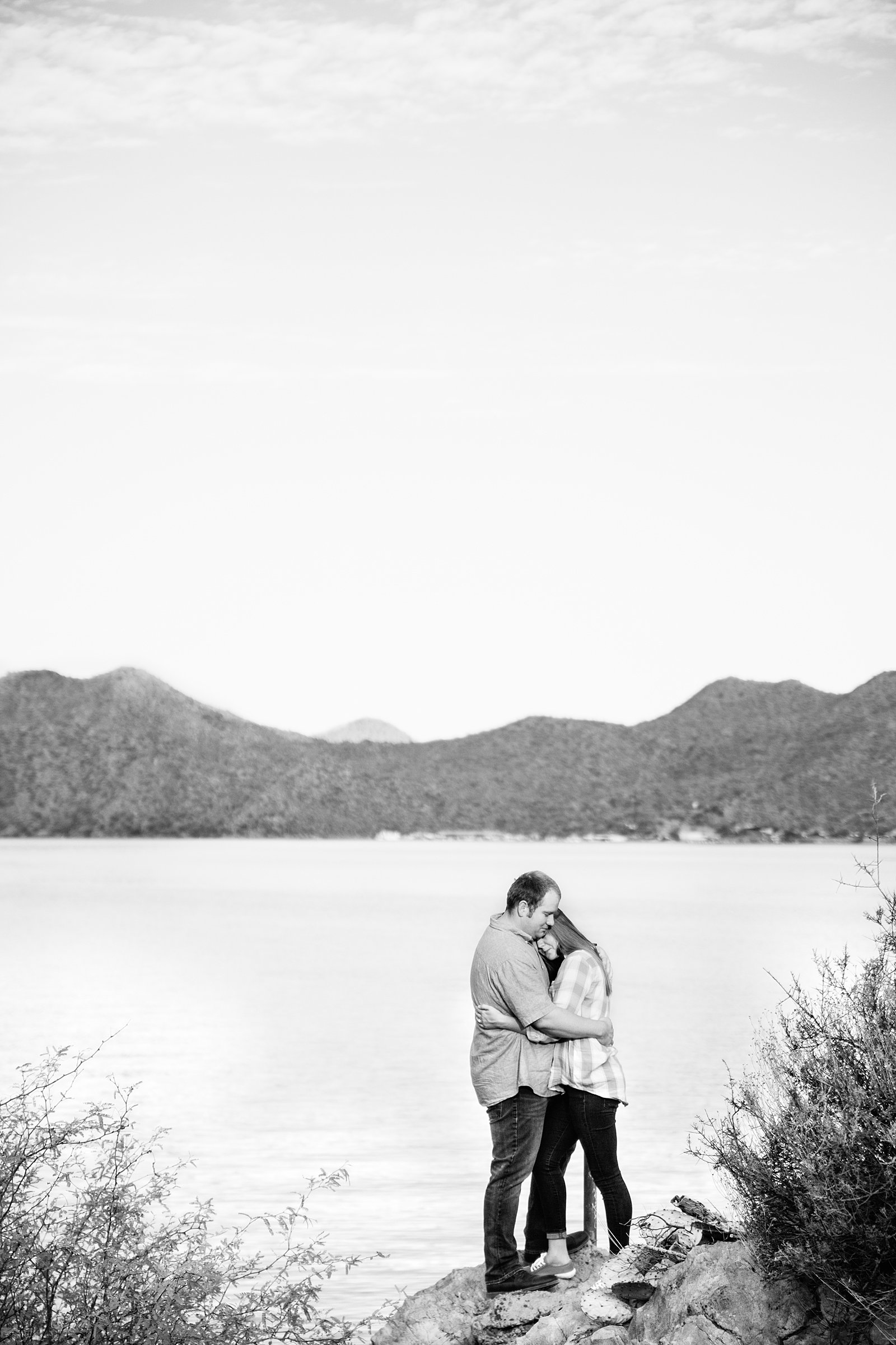 Couple share an intimate moment during their Saguaro Lake engagement session by Phoenix engagement photographer PMA Photography.