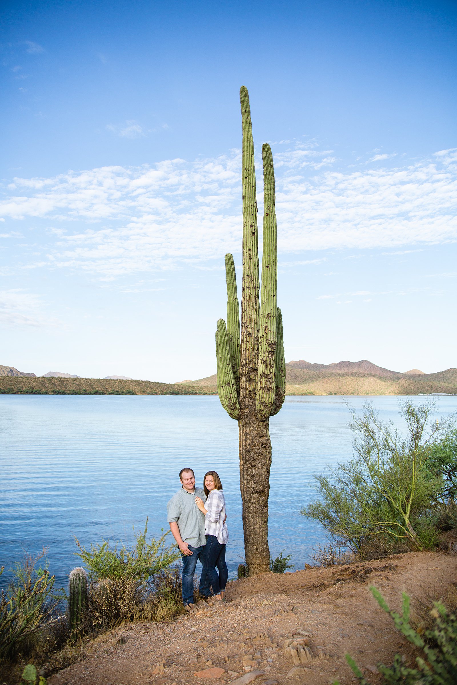 Couple pose for their Saguaro Lake engagement session by Phoenix wedding photographer PMA Photography.