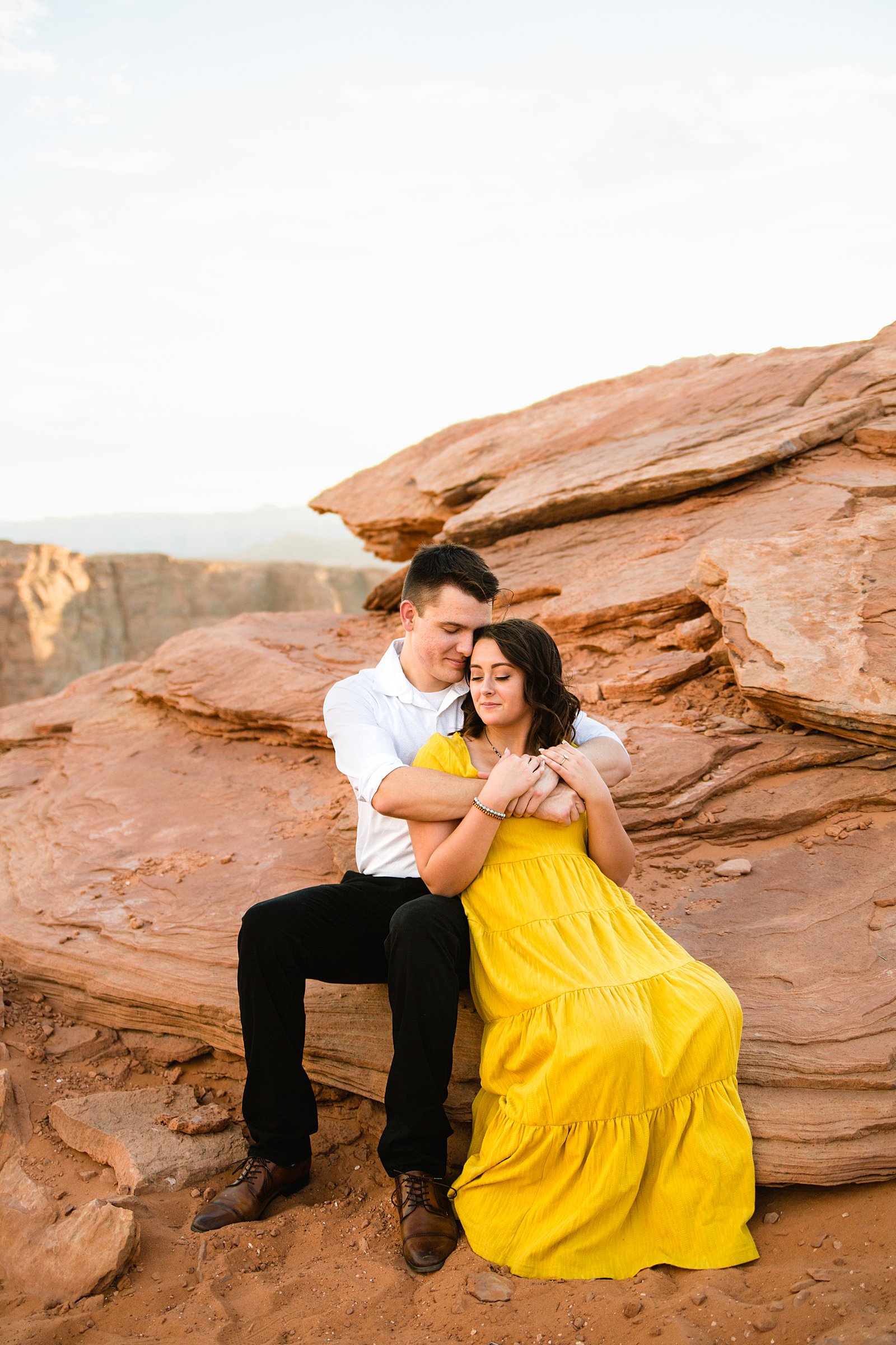 Couple share an intimate moment during their Horshoe Bend engagement session by Page engagement photographer PMA Photography.