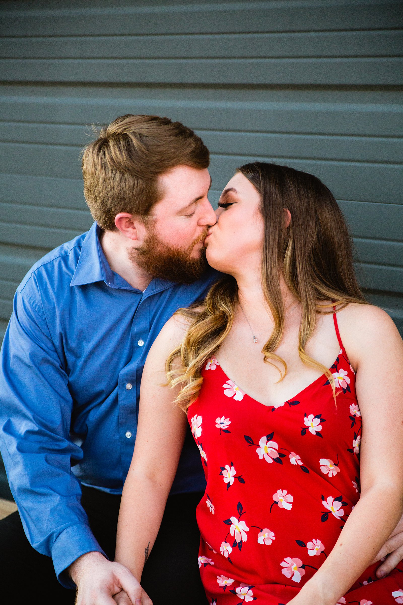 Couple share a kiss during their Helton Brewery engagement session by Phoenix wedding photographer PMA Photography.