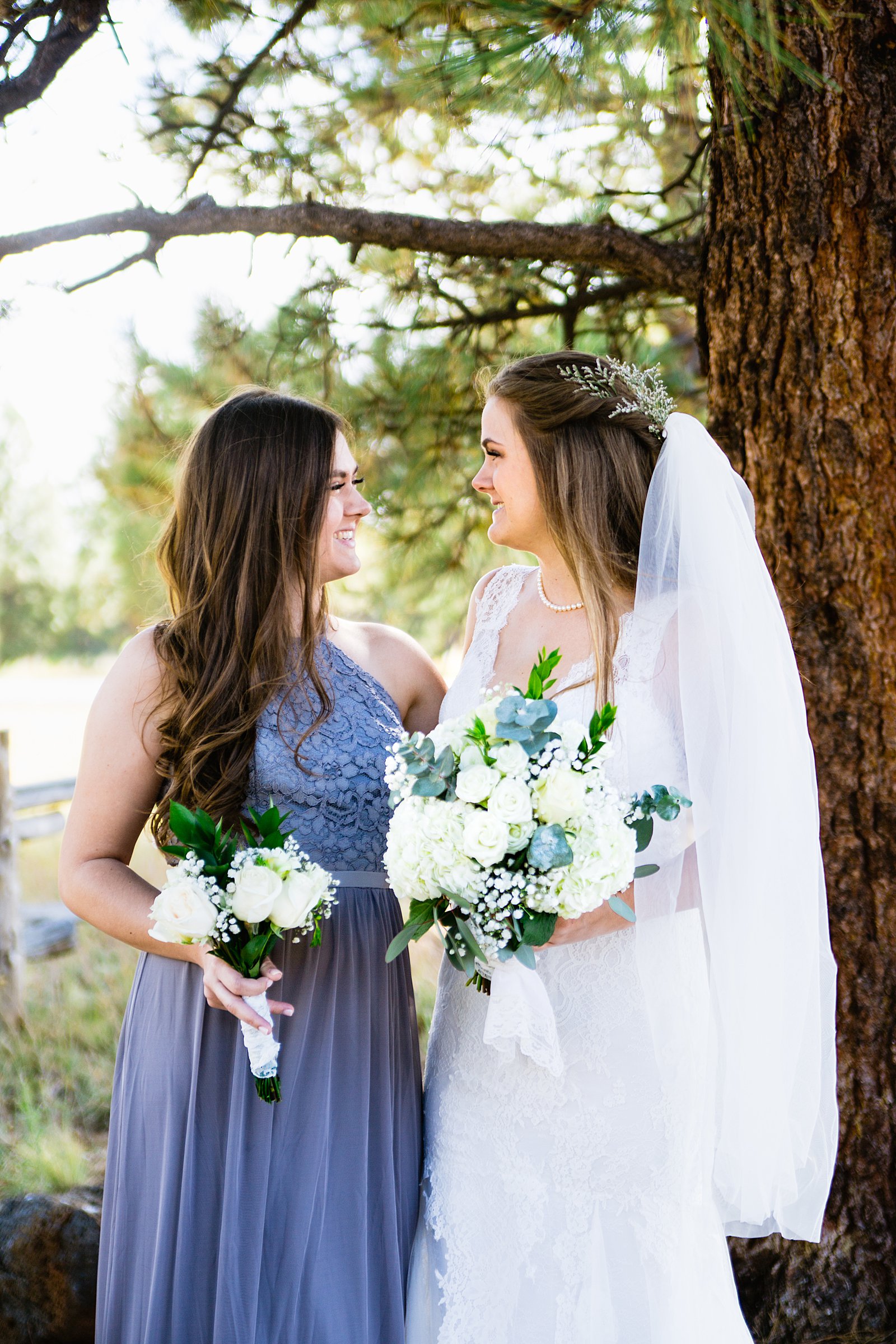Bride and bridesmaids laughing together at Chapel of the Holy Dove wedding by Flagstaff wedding photographer PMA Photography.