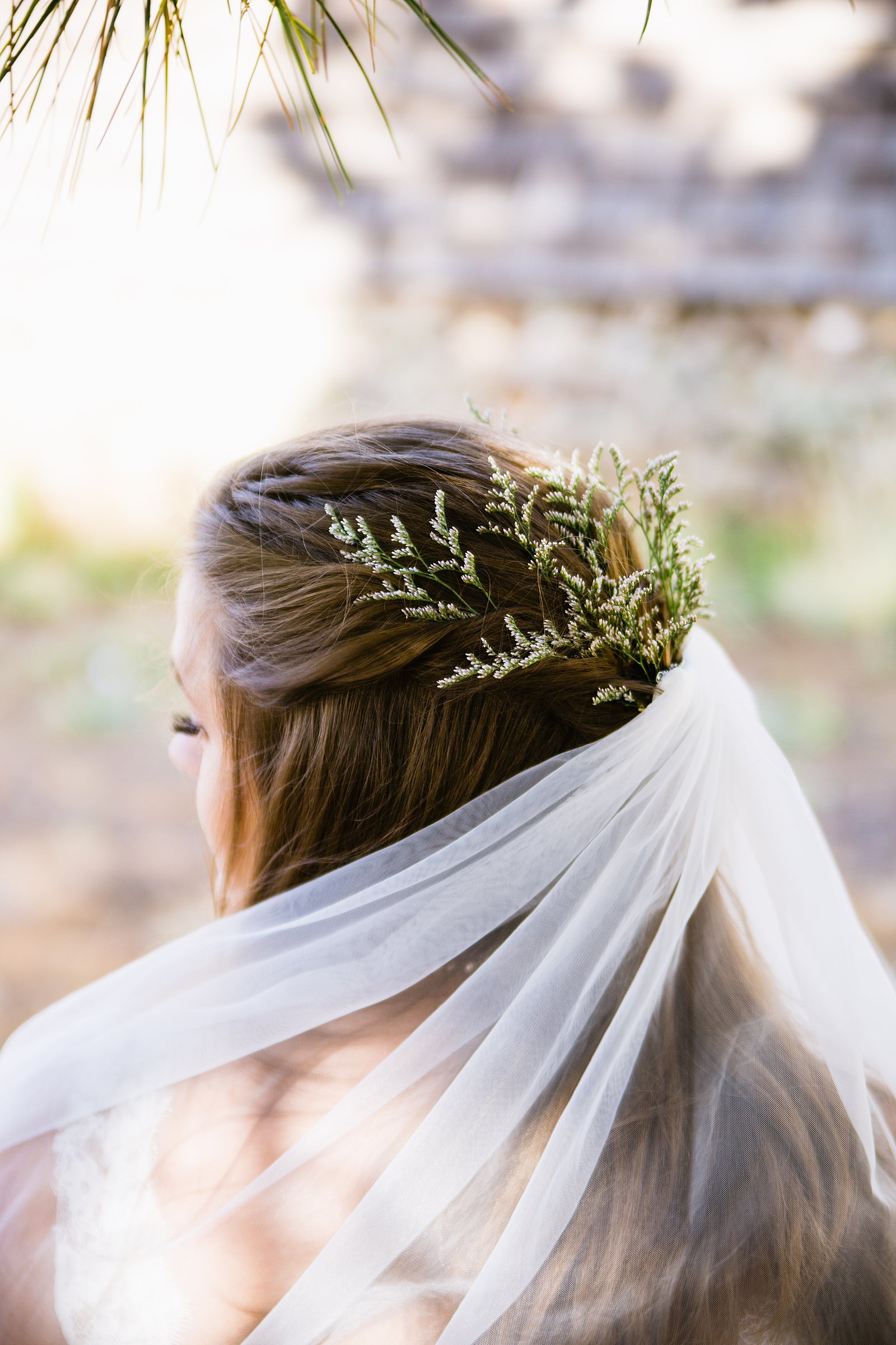 Bride's simple floral half updo with veil by Arizona wedding photographers PMA Photography.