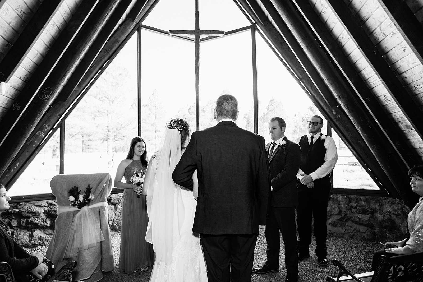 Bride walking down aisle during Chapel of the Holy Dove wedding ceremony by Arizona wedding photographer PMA Photography.