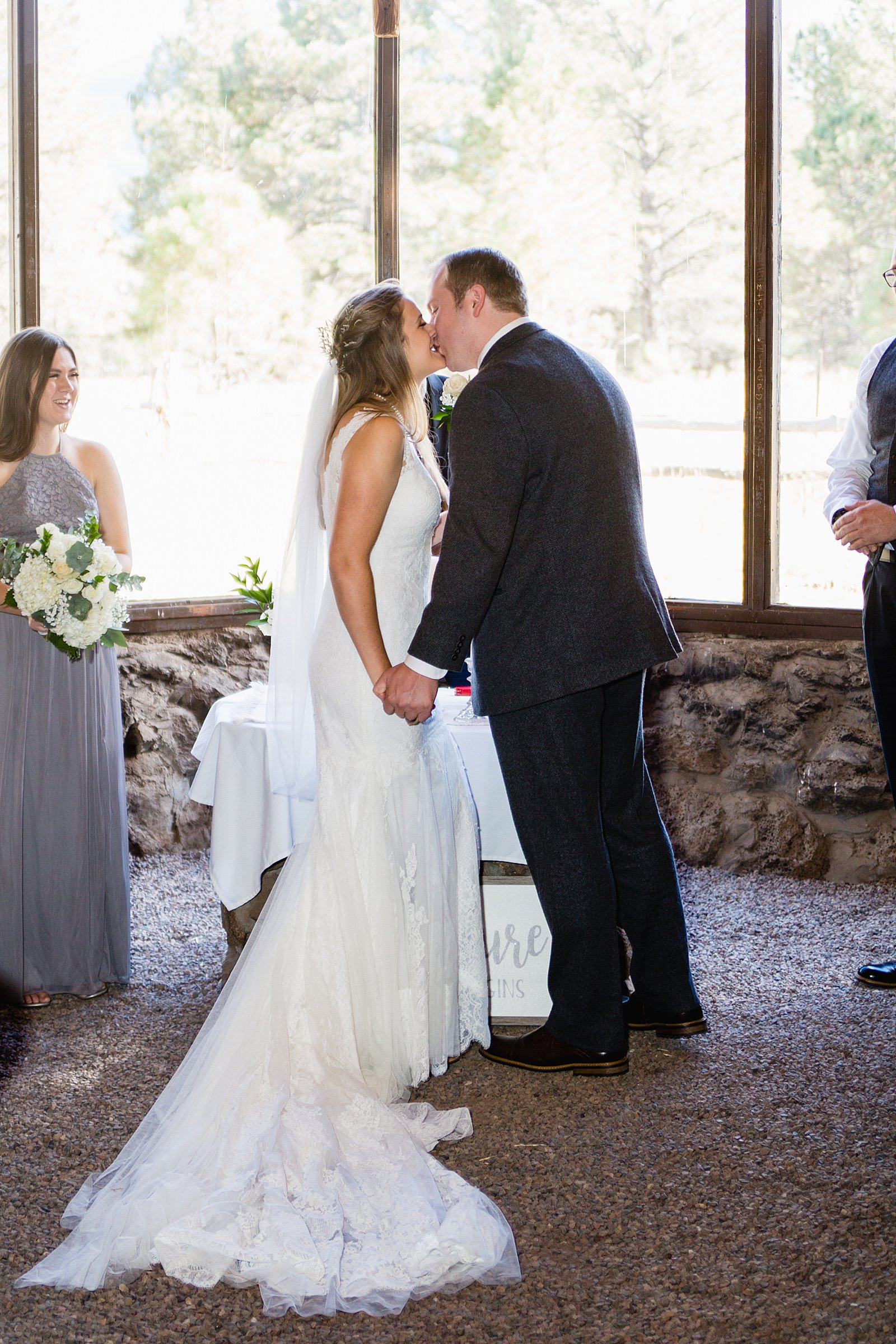 Bride and Groom share their first kiss during their wedding ceremony at Chapel of the Holy Dove by Arizona wedding photographer PMA Photography.