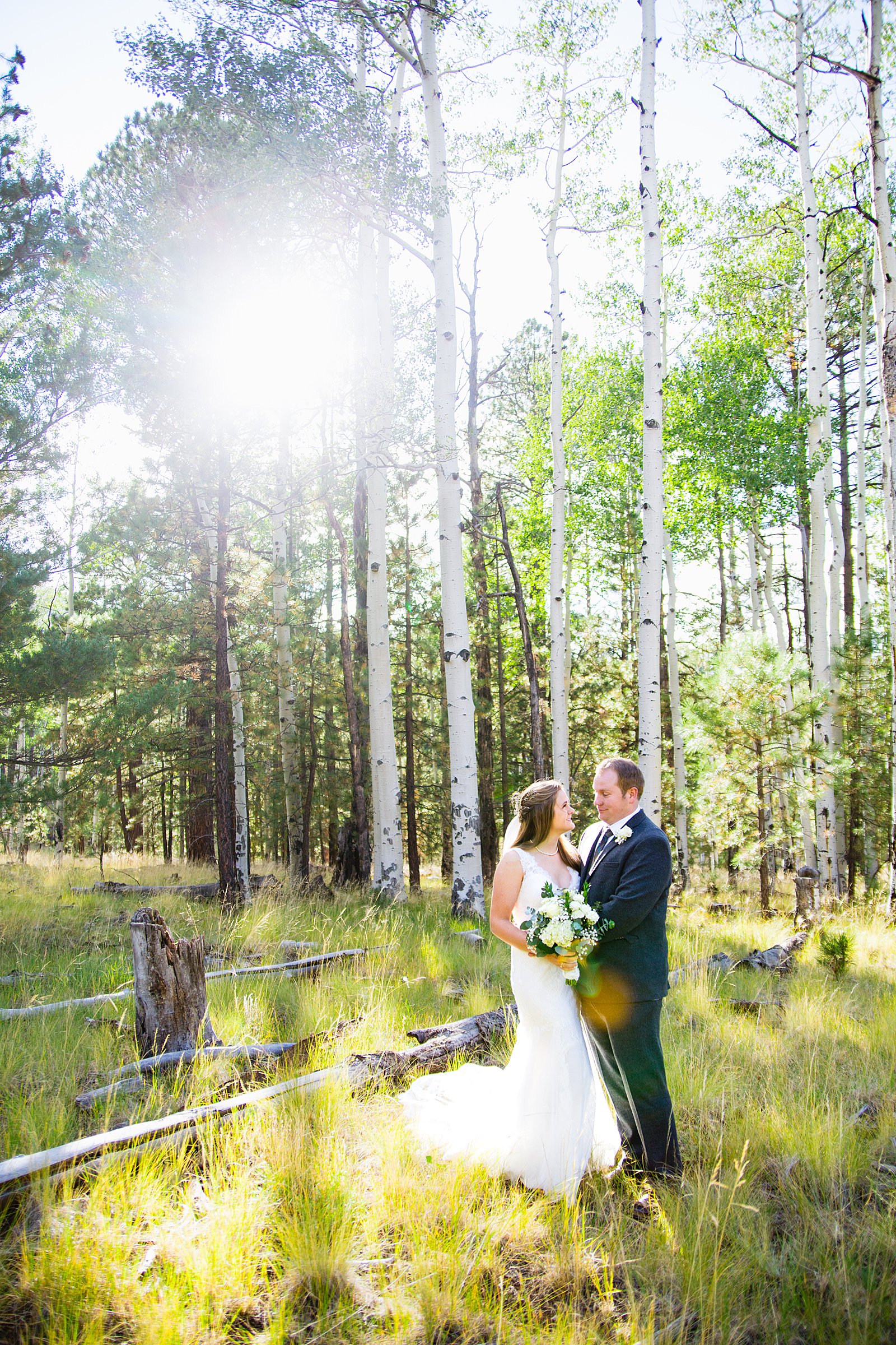 Bride and Groom pose for their Chapel of the Holy Dove wedding by Flagstaff wedding photographer PMA Photography.