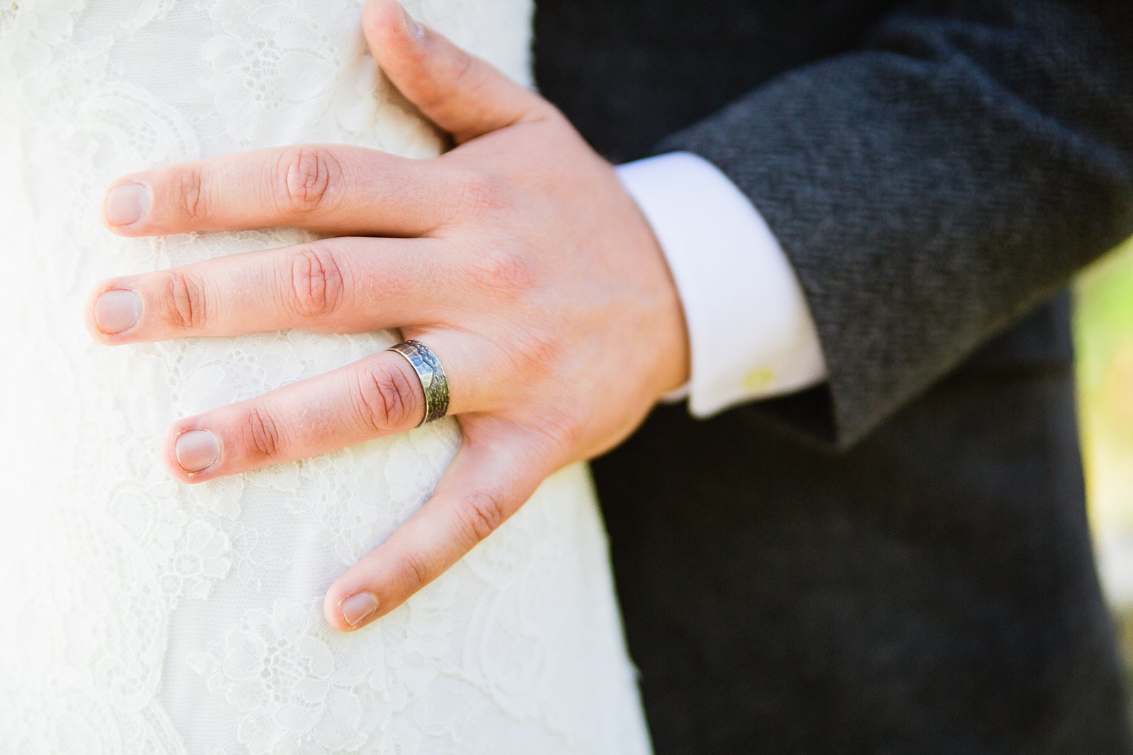 Groom's custom wedding ring designed to look like the local mountain range by PMA Photography.