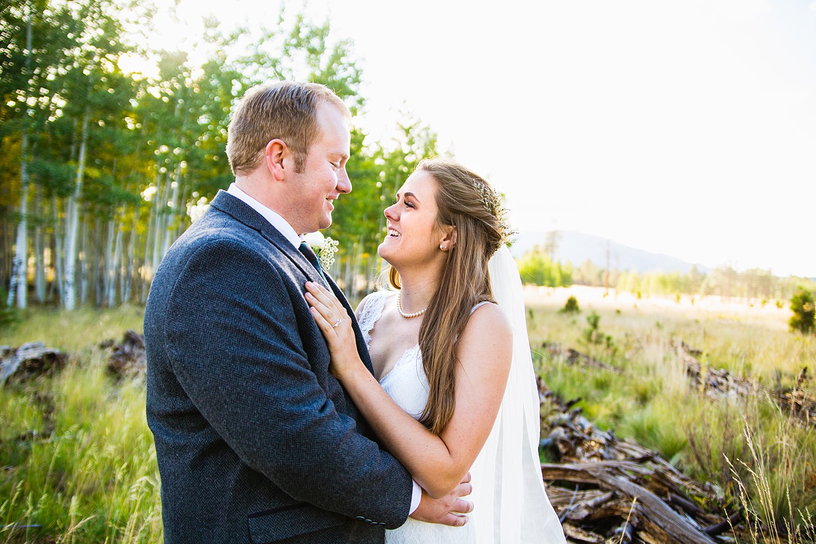 Bride and Groom laughing together during their Chapel of the Holy Dove wedding by Arizona wedding photographer PMA Photography.