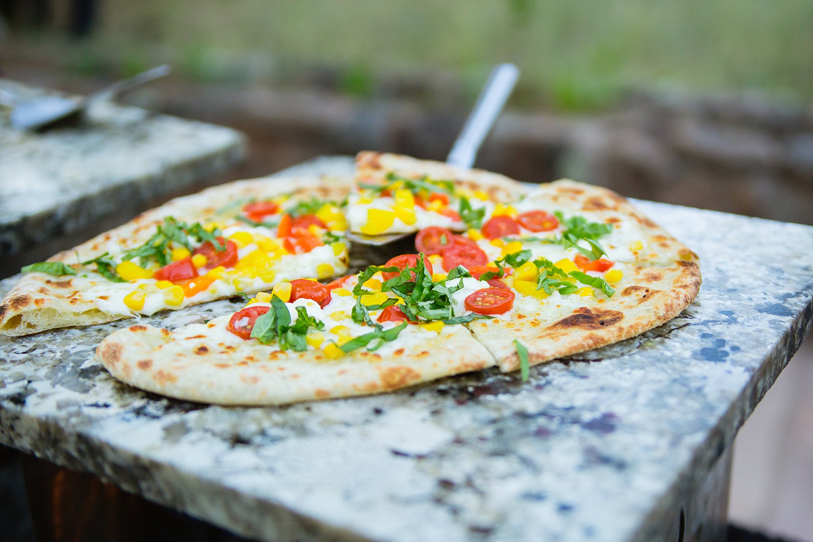 Into The Fire Pizza serving fresh pizza at a wedding reception at The Colton House in Flagstaff by PMA Photography.