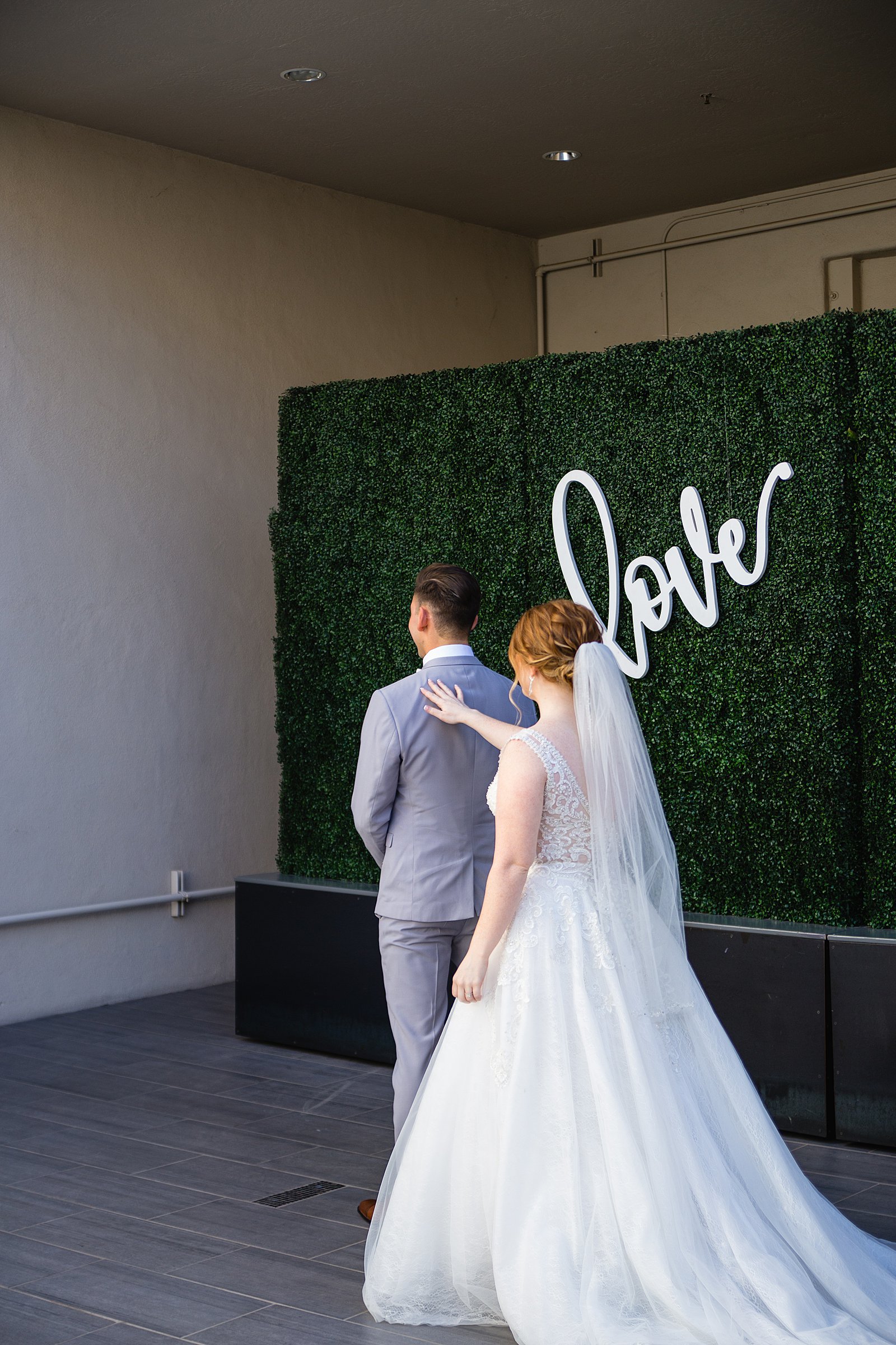 Bride and Groom's first look at SoHo63 by Phoenix wedding photographer PMA Photography.