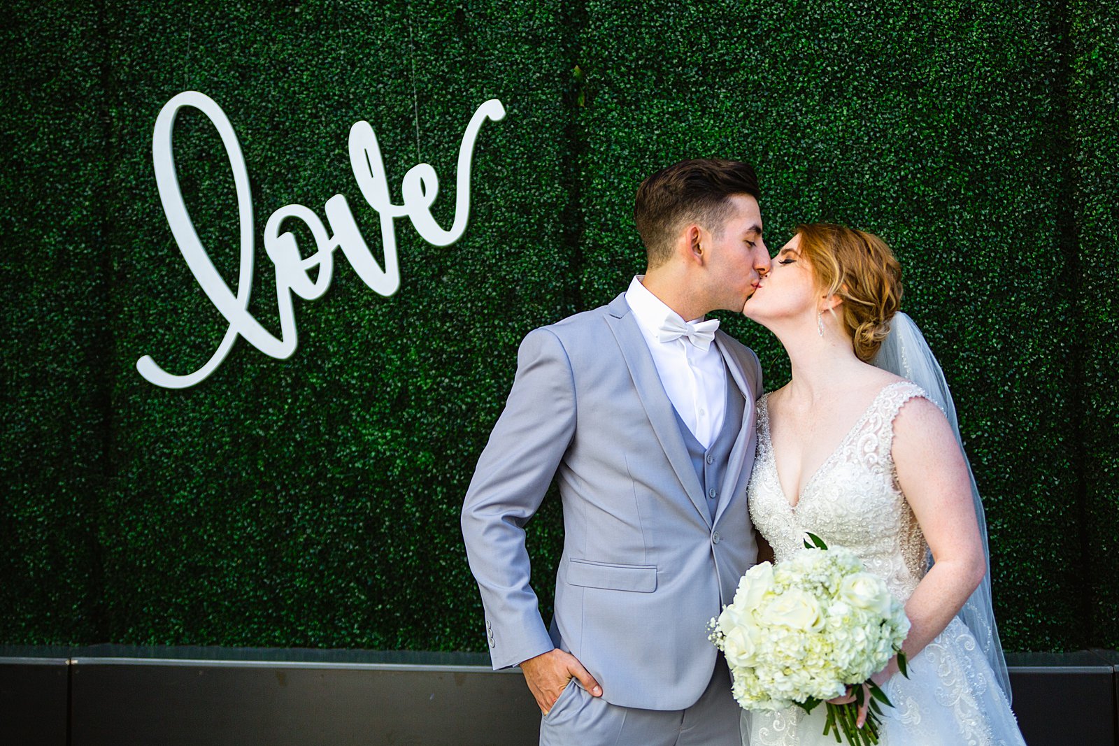 Bride and Groom share a kiss during their SoHo63 wedding by Arizona wedding photographer PMA Photography.