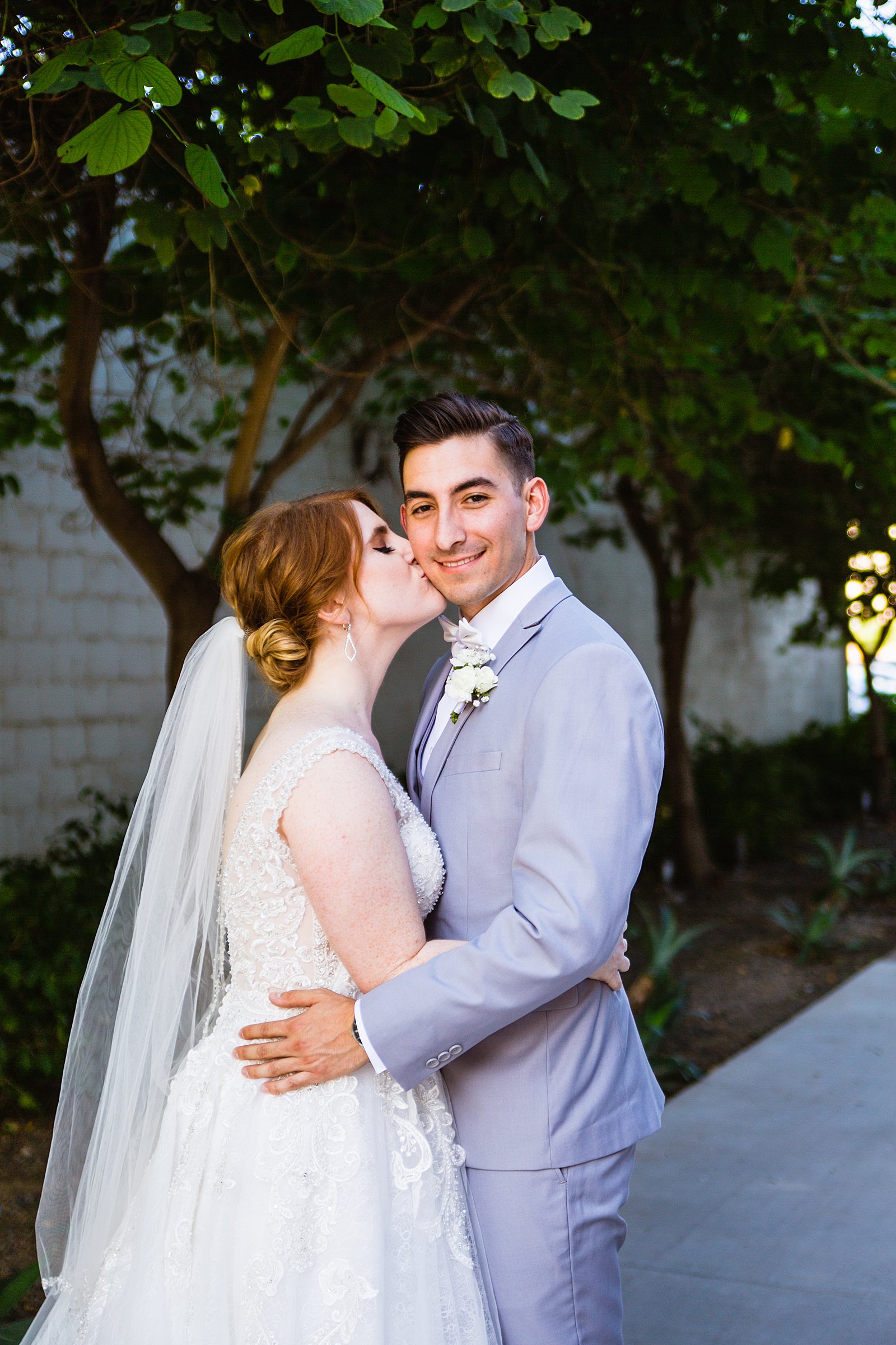 Bride and Groom share a kiss during their SoHo63 wedding by Arizona wedding photographer PMA Photography.