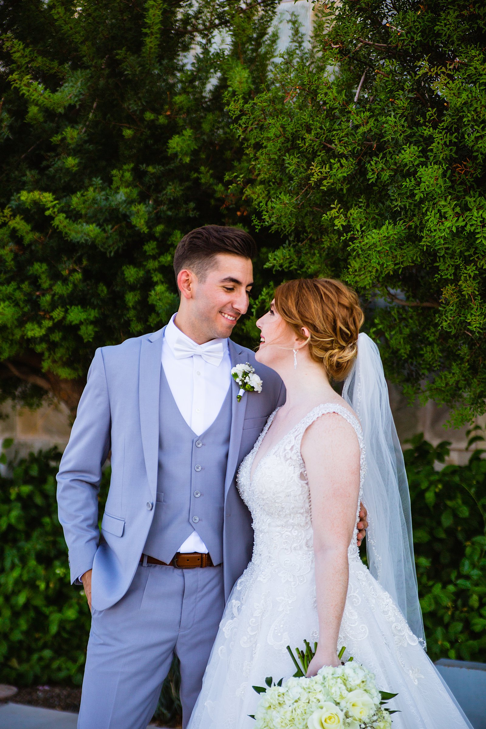 Bride and Groom laughing together during their SoHo63 wedding by Arizona wedding photographer PMA Photography.