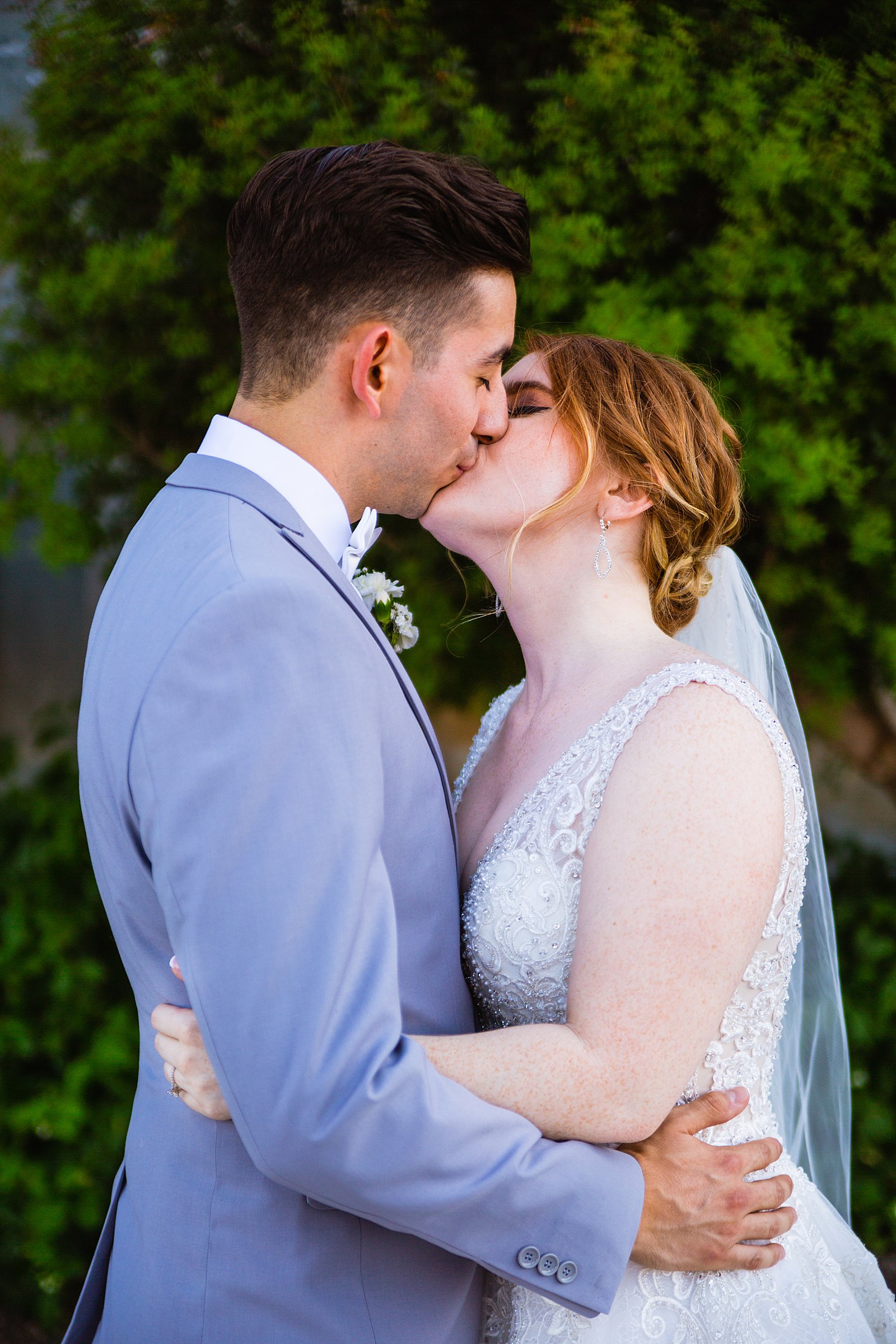 Bride and Groom share a kiss during their SoHo63 wedding by Chandler wedding photographer PMA Photography.