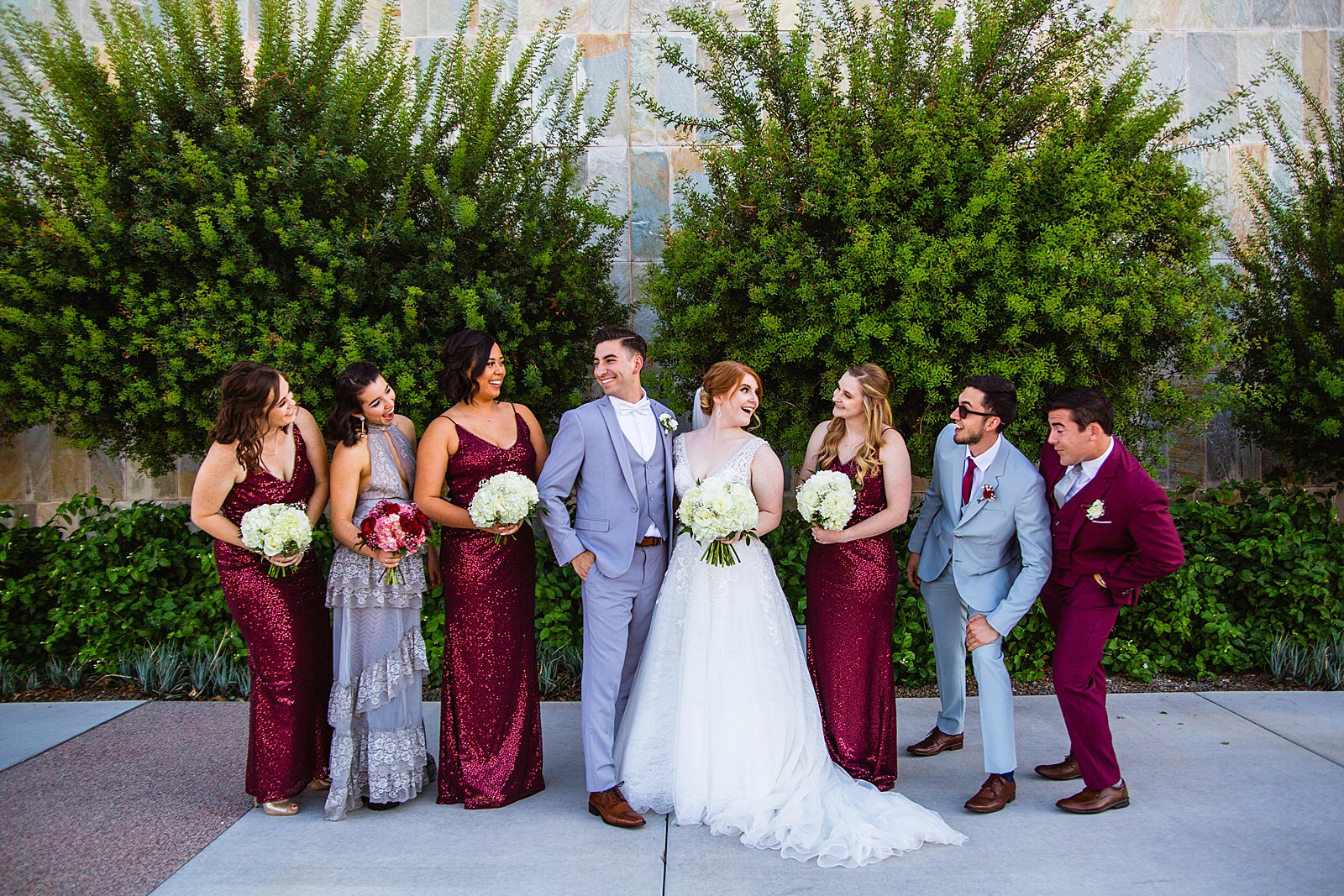 Mixed gender bridal party laughing together at SoHo63 wedding by Chandler wedding photographer PMA Photography.