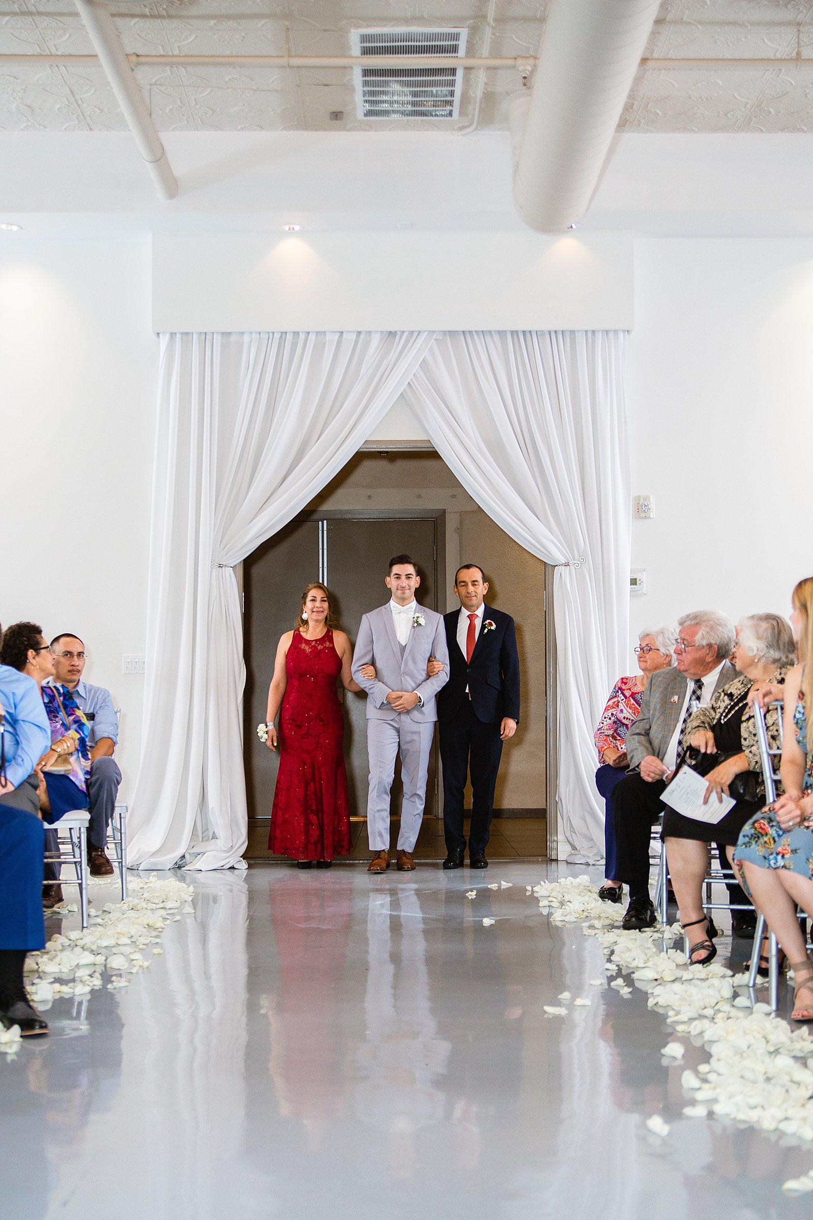 Groom walking down aisle during SoHo63 wedding ceremony by Phoenix wedding photographer PMA Photography.