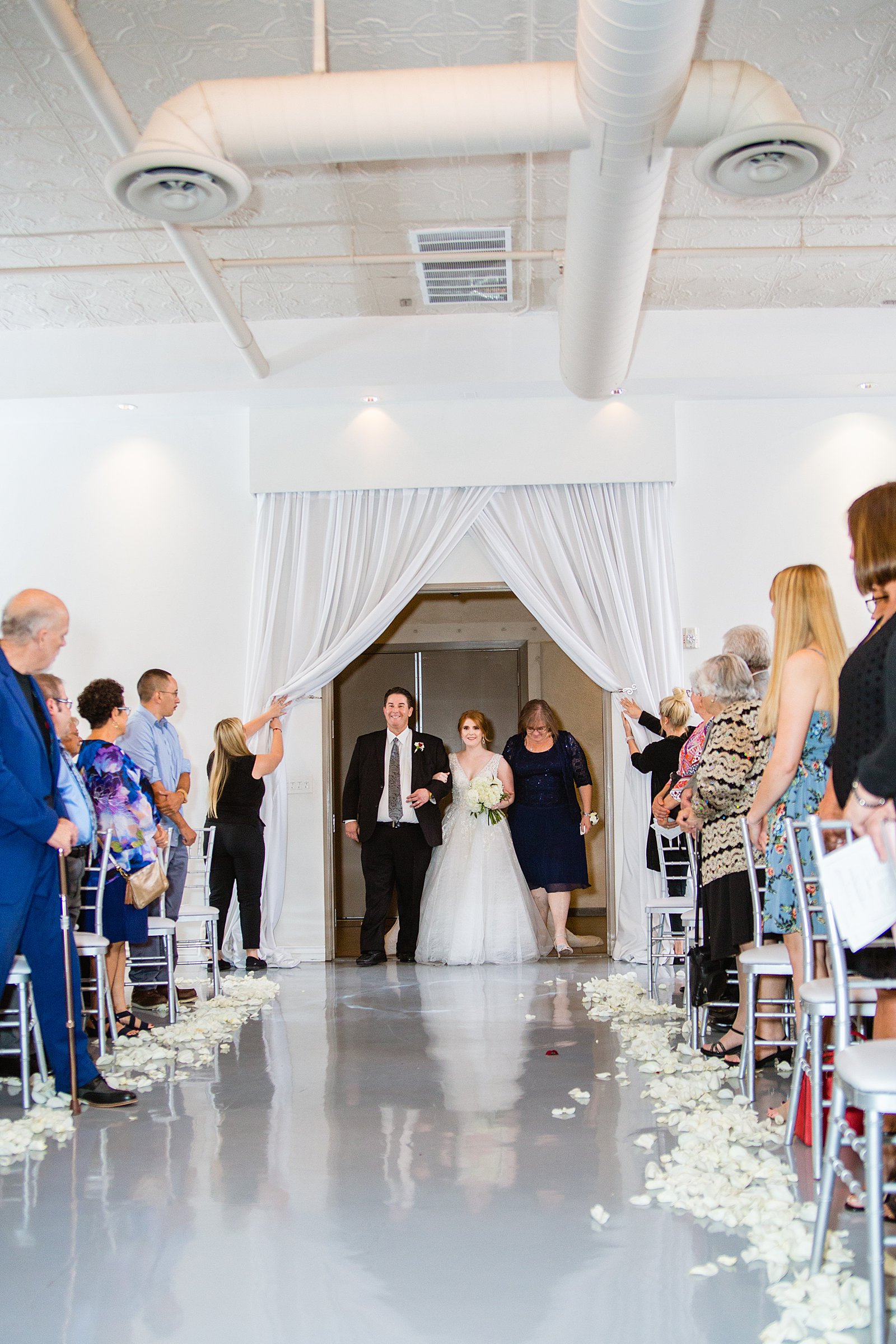 Bride walking down aisle during SoHo63 wedding ceremony by Phoenix wedding photographer PMA Photography.