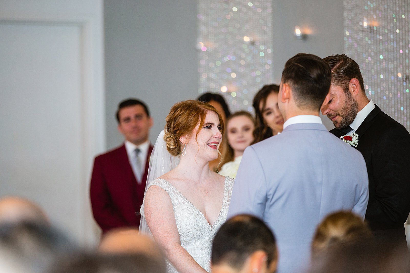 Bride looking at her groom during their wedding ceremony at SoHo63 by Chandler wedding photographer PMA Photography.