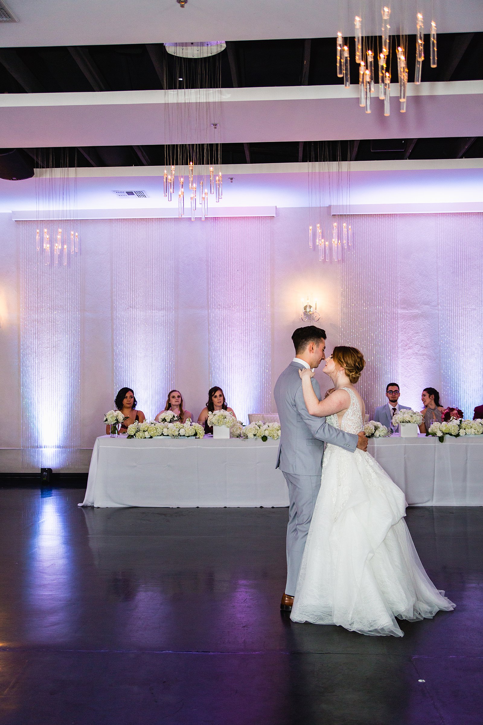 Bride and Groom sharing first dance at their SoHo63 wedding reception by Arizona wedding photographer PMA Photography.