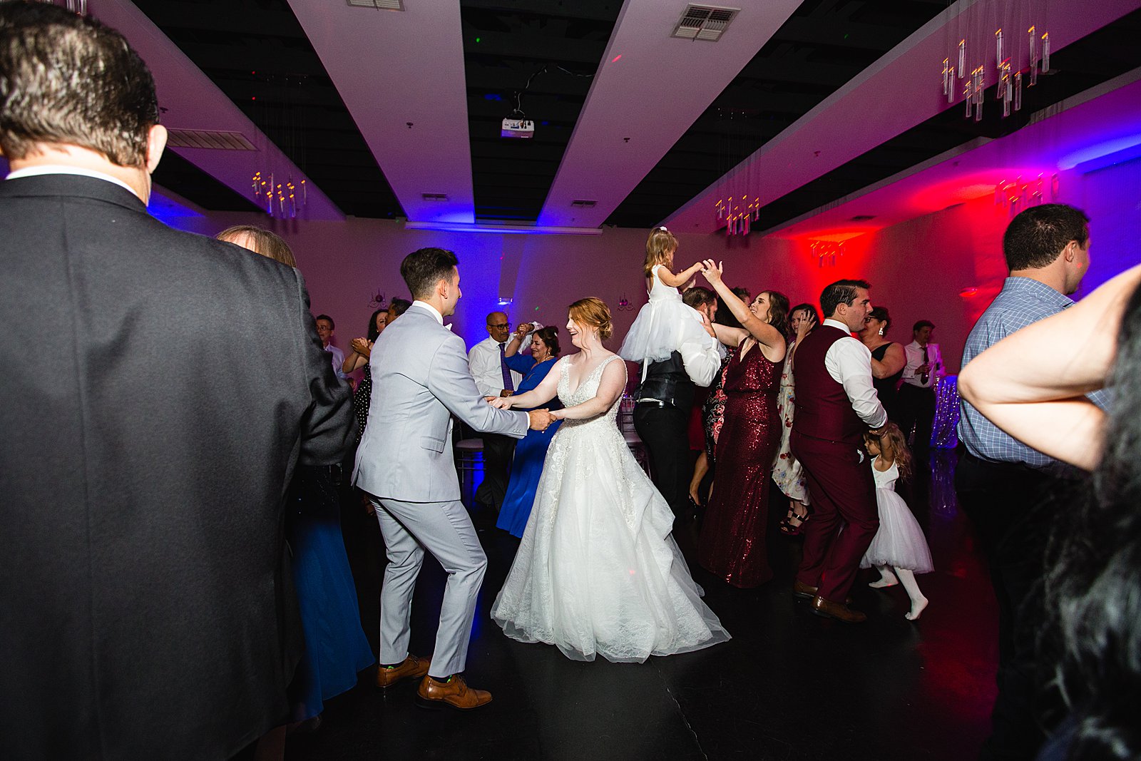Bride and groom dancing with guests at SoHo63 wedding reception by Chandler wedding photographer PMA Photography