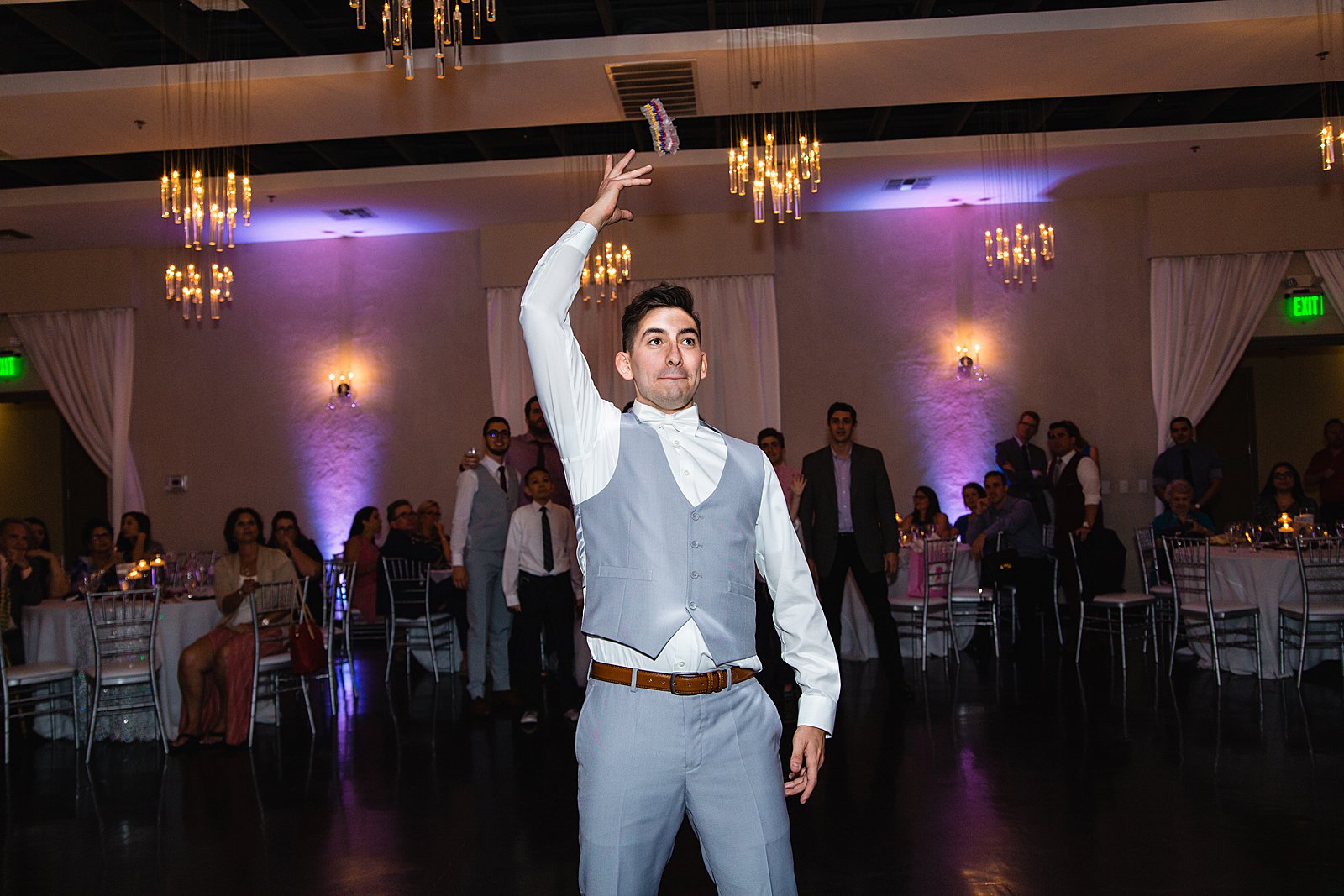 Garter toss at SoHo63 wedding reception by Chandler wedding photographer PMA Photography.