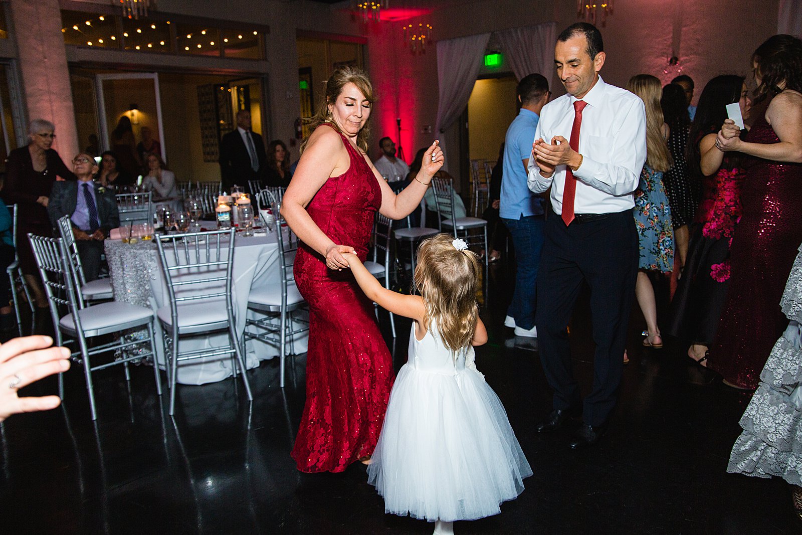 Guests dancing together at a SoHo63 wedding reception by PMA Photography.