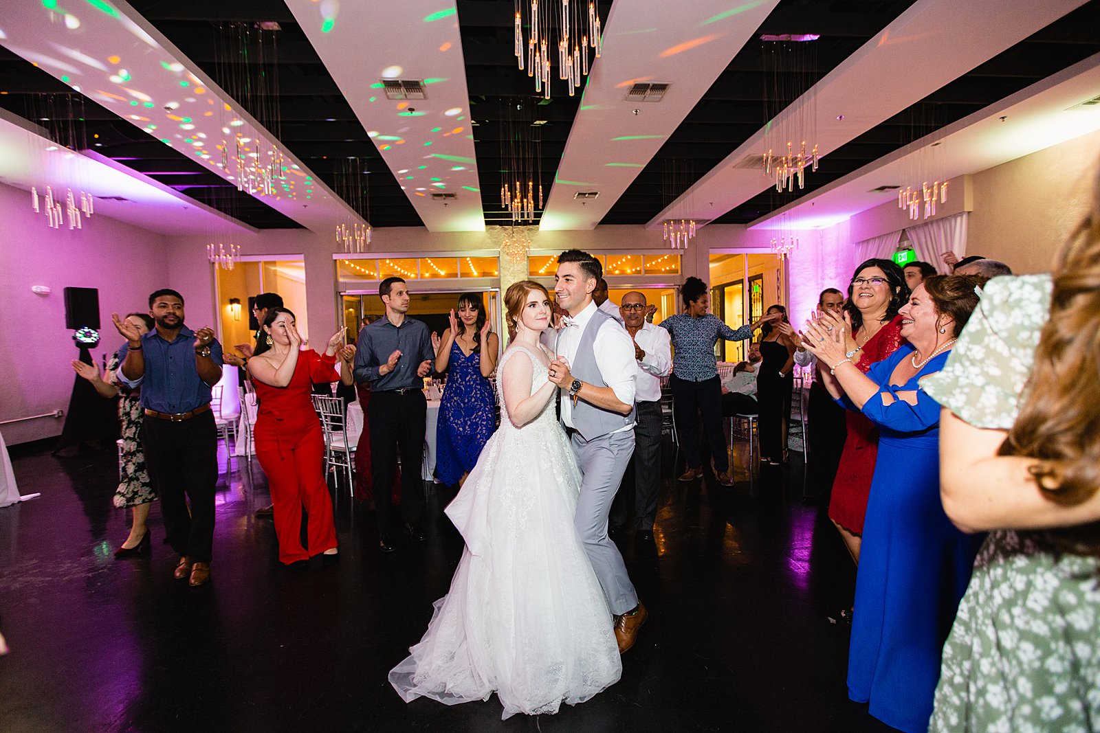 Bride and groom dancing with guests at SoHo63 wedding reception by Chandler wedding photographer PMA Photography