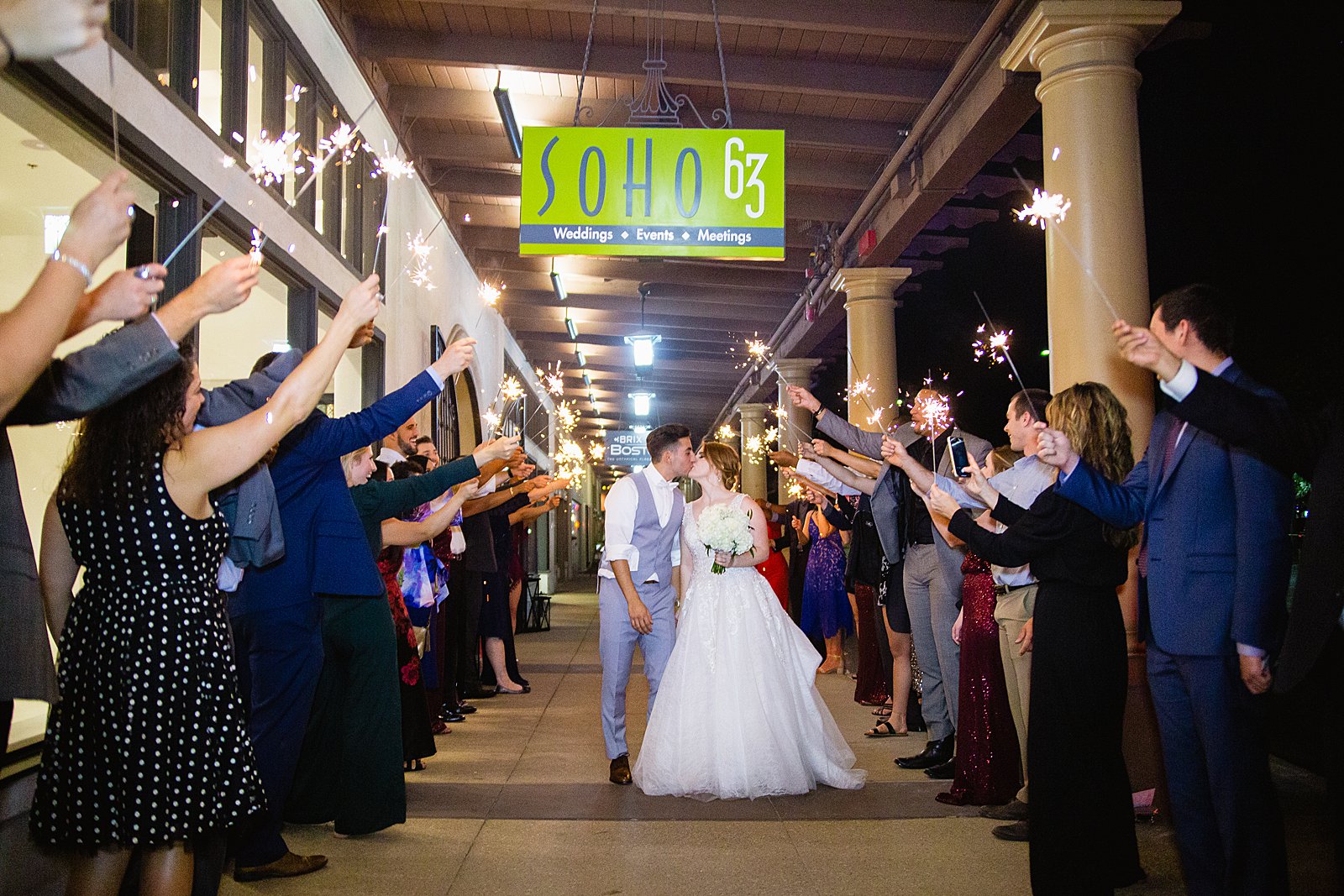Bride and groom's sparkler exit at SoHo63 wedding venue by PMA Photography.