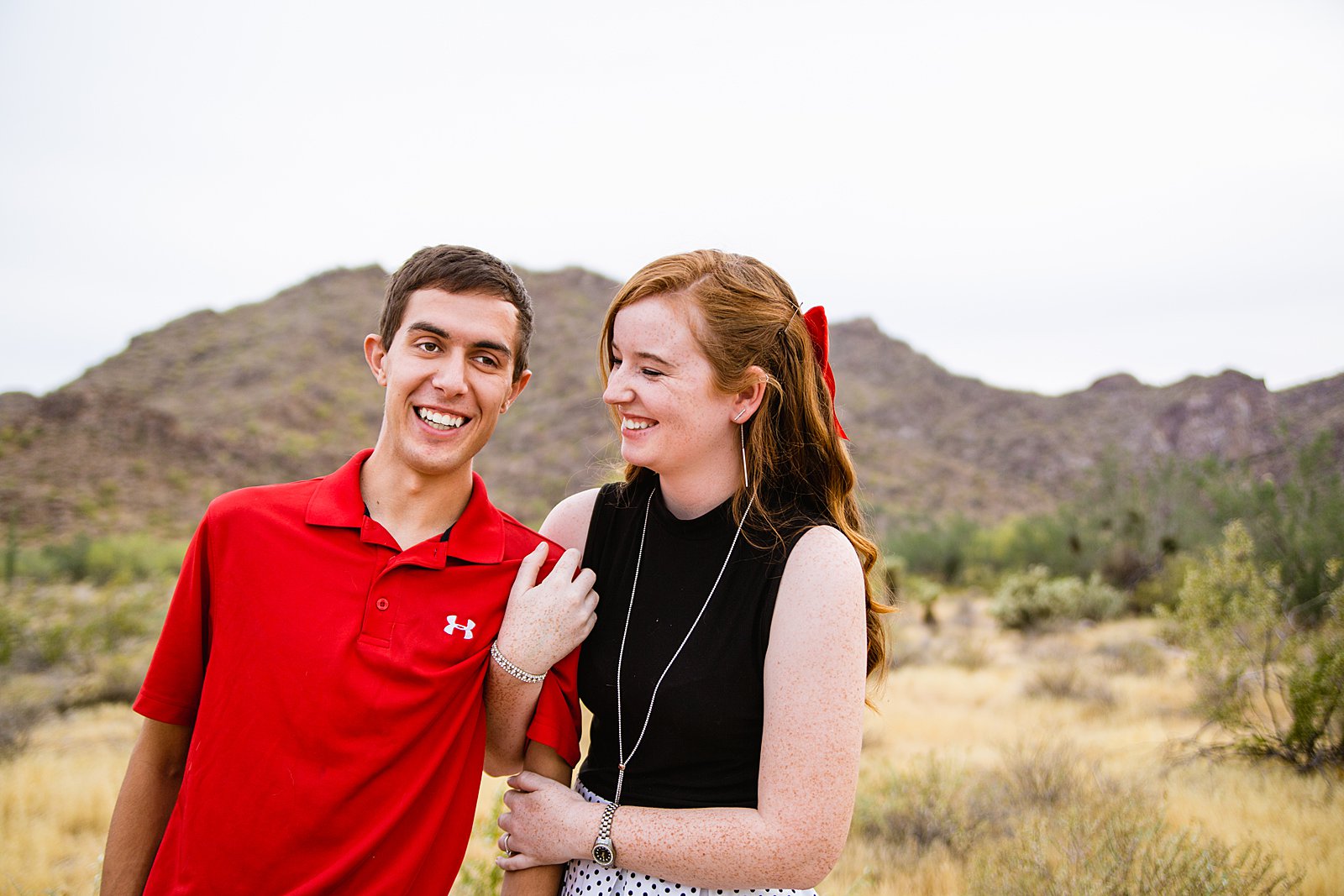 Couple laugh together during their White Tanks anniversary session by Phoenix engagement photographer PMA Photography.