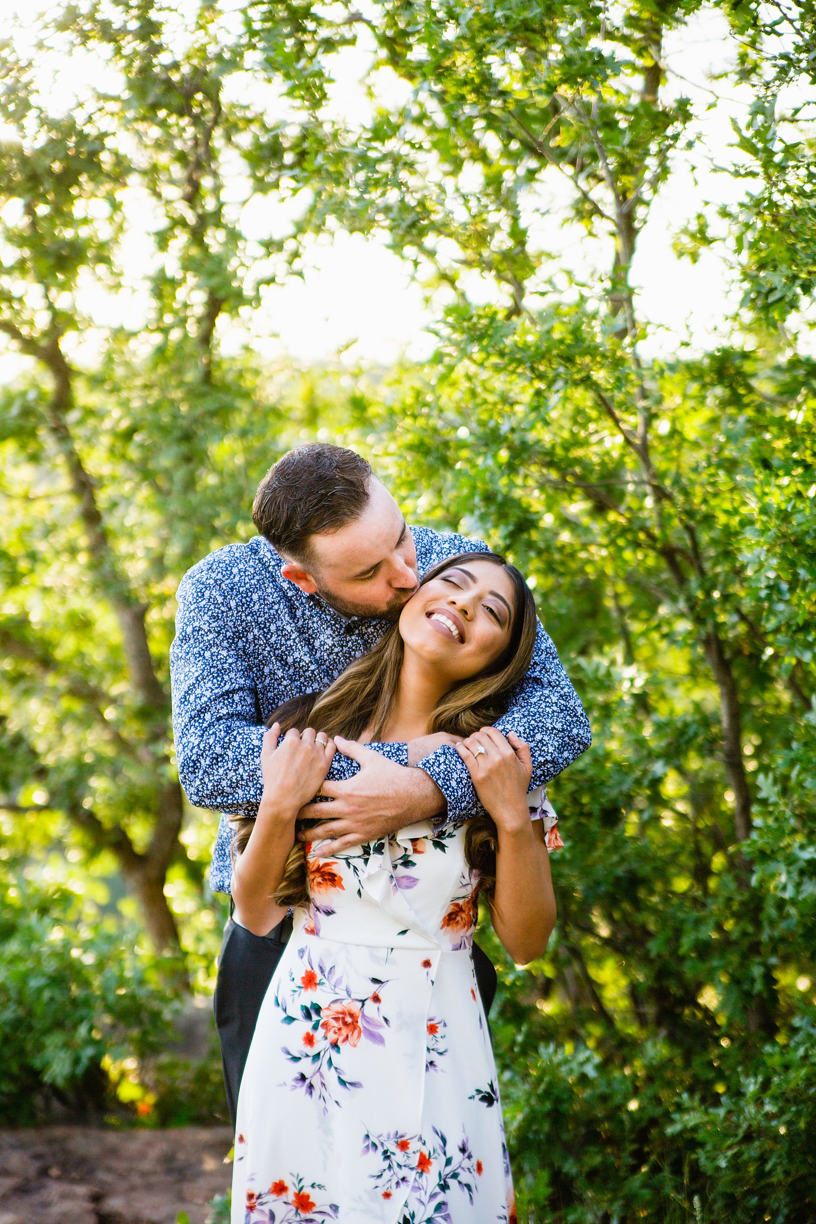 Couple share a kiss during their Mogollon Rim engagement session by Payson wedding photographer PMA Photography.