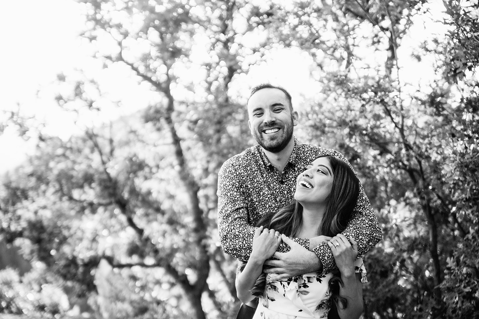 Couple laugh together during their Payson engagement session by Arizona engagement photographer PMA Photography.