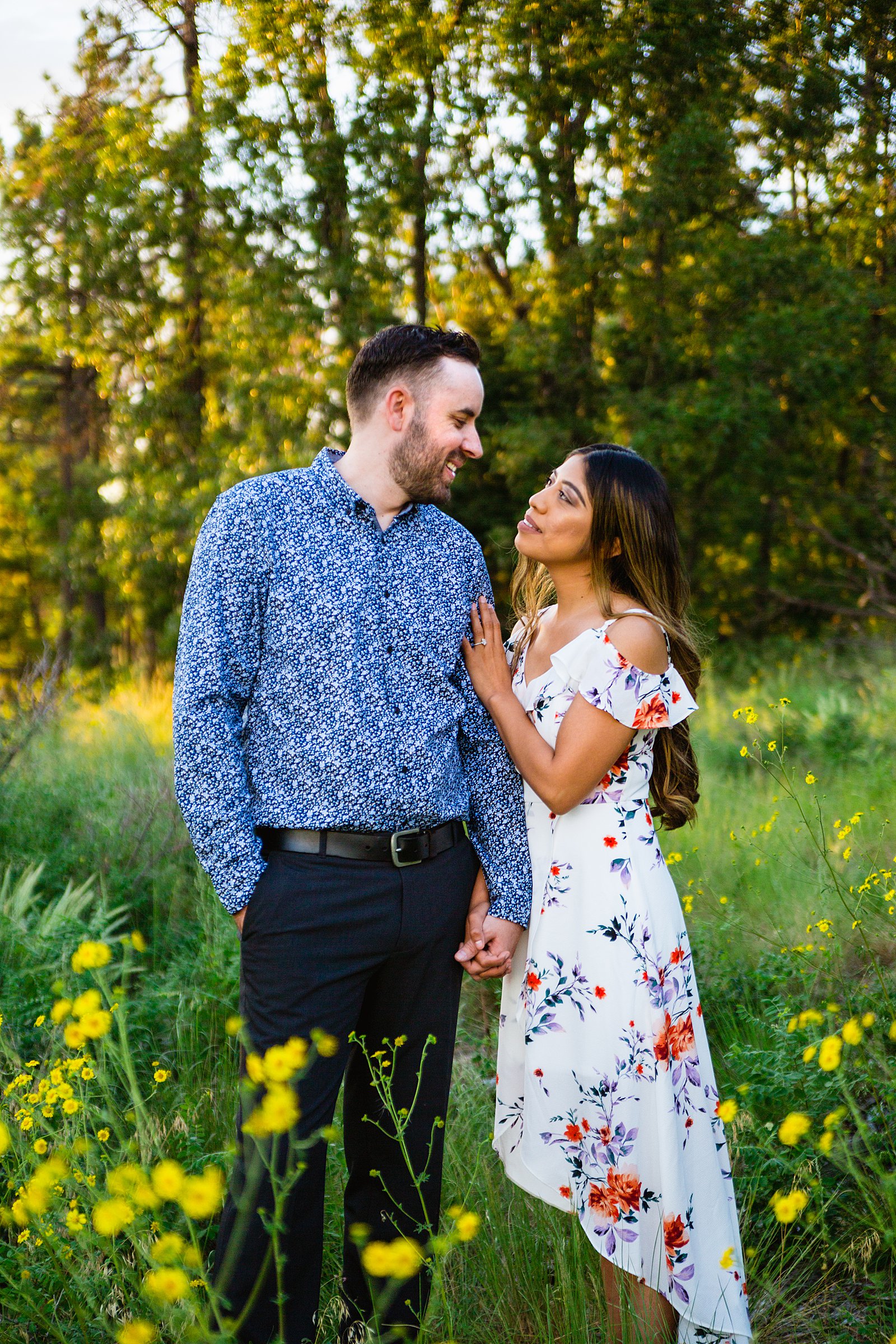 Couple look at each other during their Payson engagement session by Arizona wedding photographer PMA Photography.