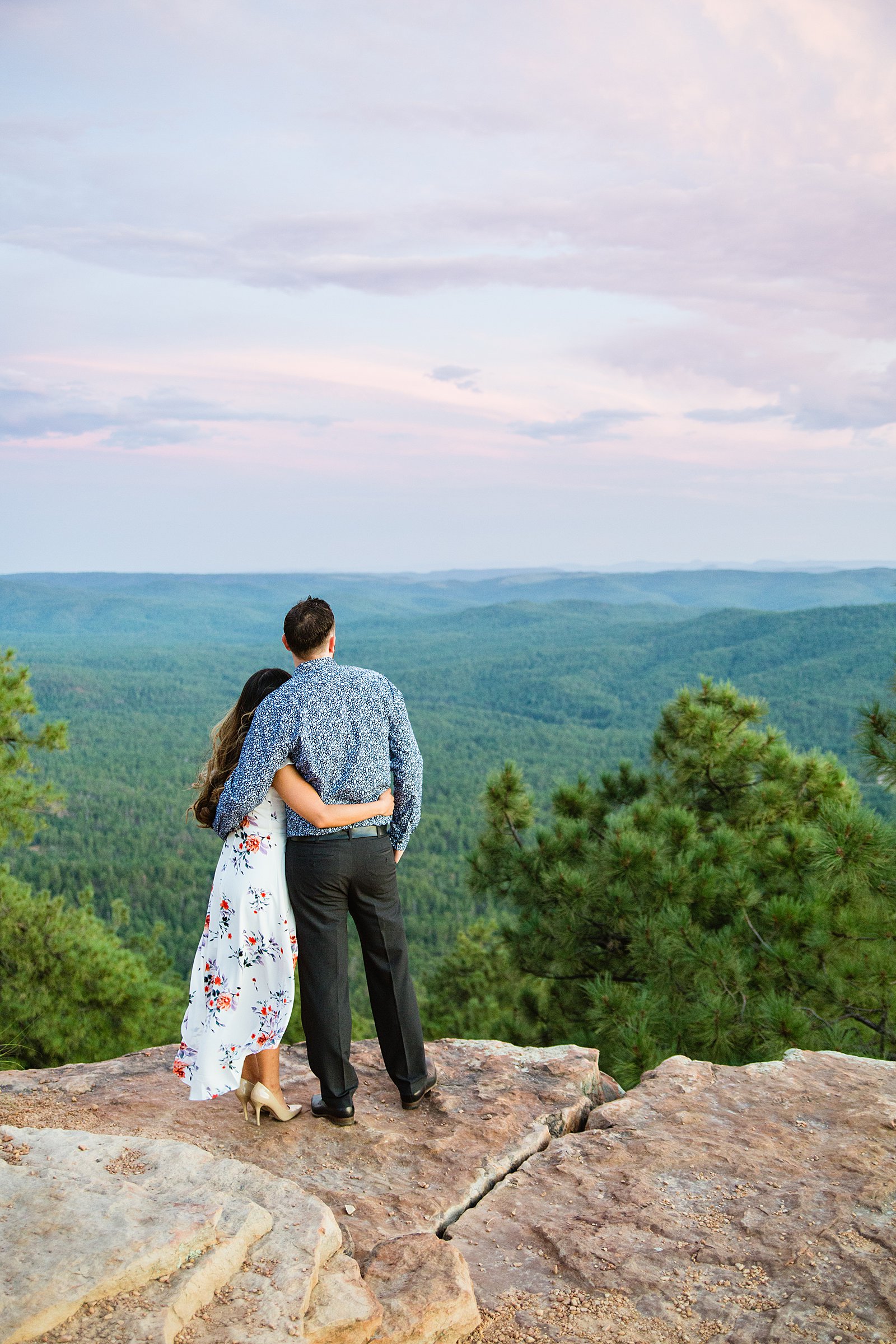 Couple looking at the view during their Mogollon Rim engagement session by Payson wedding photographer PMA Photography.