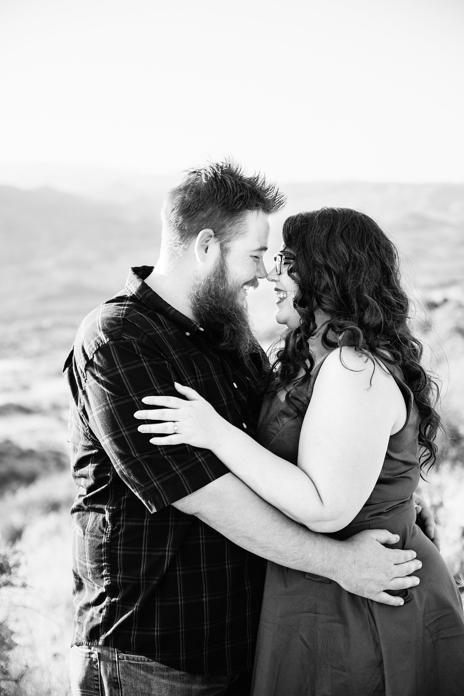 Couple laugh together during their Sunset Point engagement session by Phoenix engagement photographer PMA Photography.