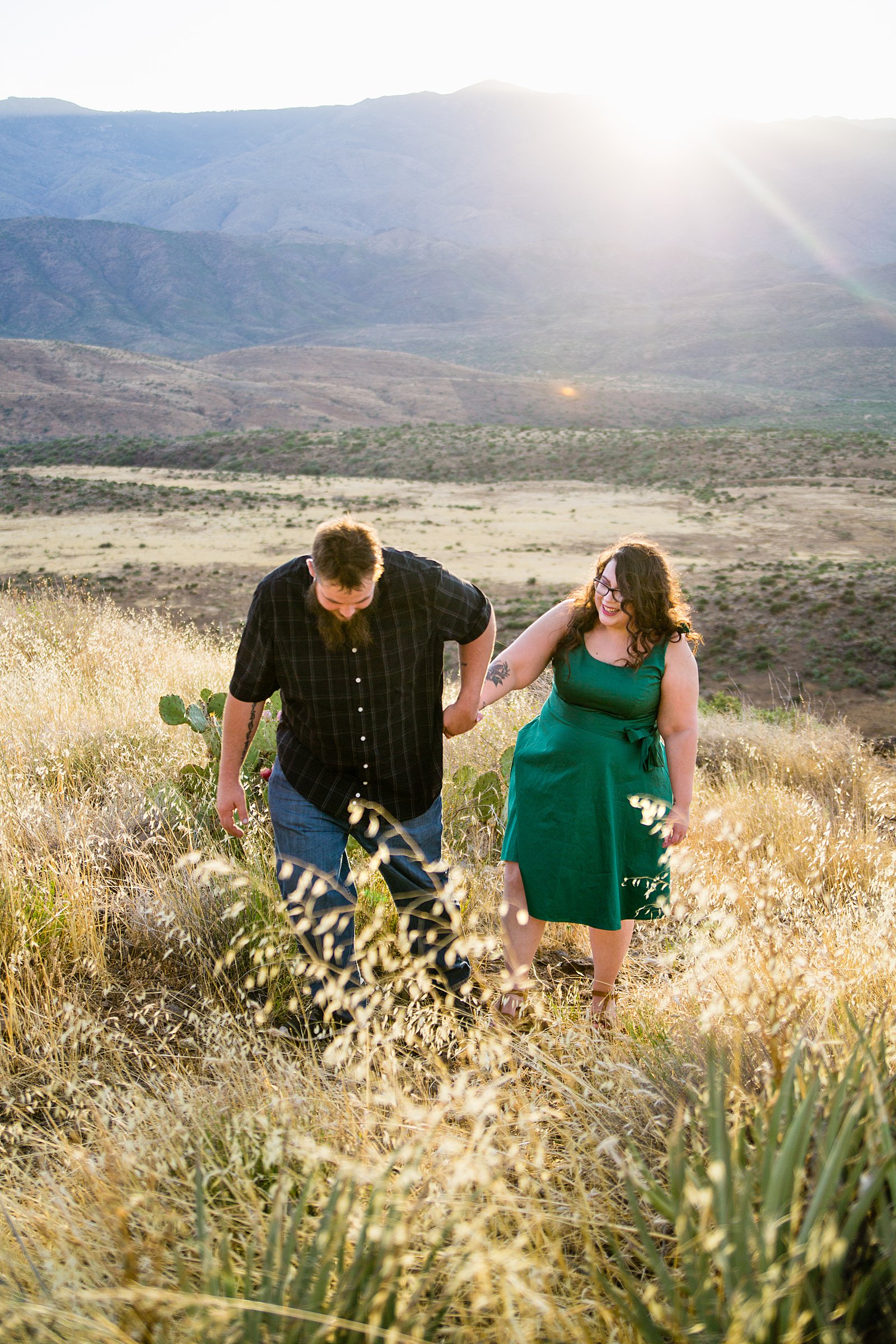Couple walking together during their Sunset Point engagement session by Phoenix engagement photographer PMA Photography.