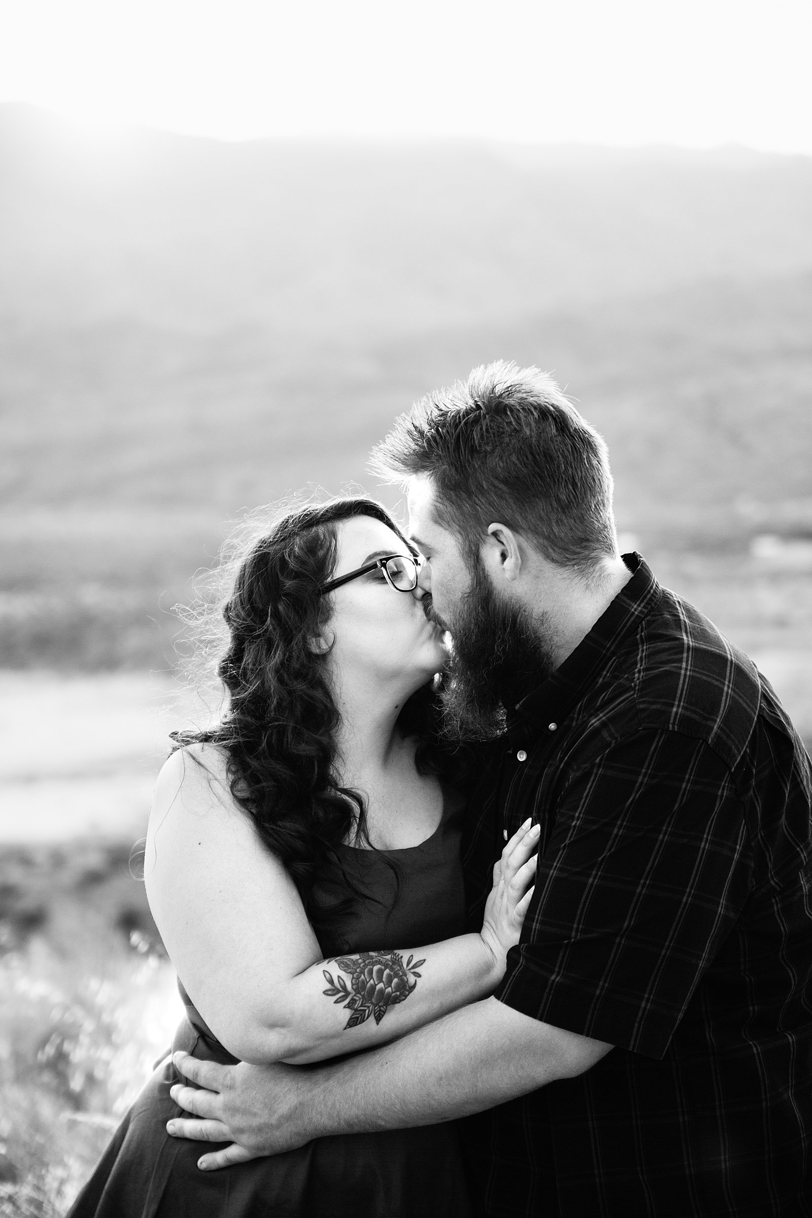 Couple share a kiss during their Sunset Point engagement session by Phoenix wedding photographer PMA Photography.