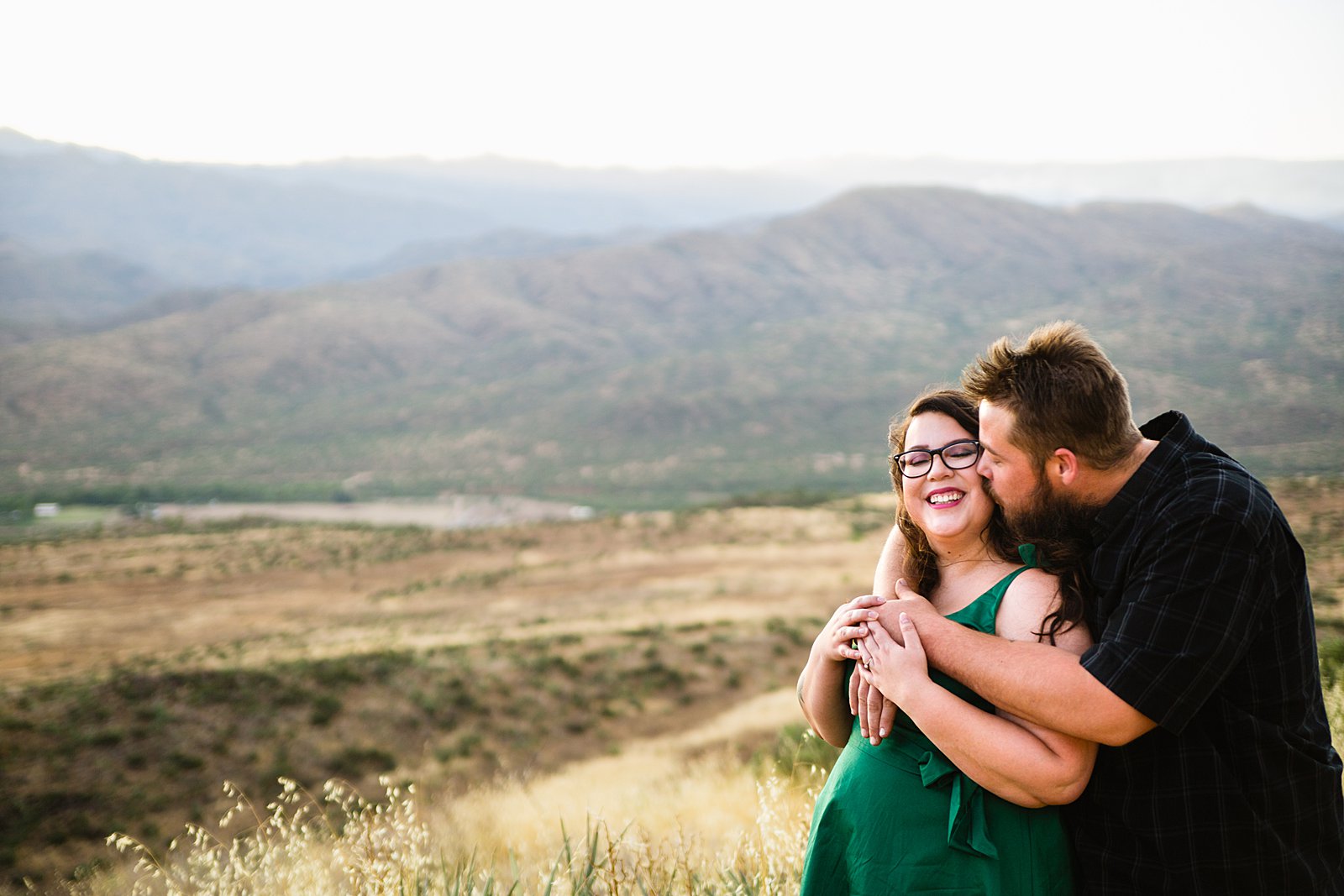 Couple share a kiss during their Sunset Point engagement session by Phoenix wedding photographer PMA Photography.