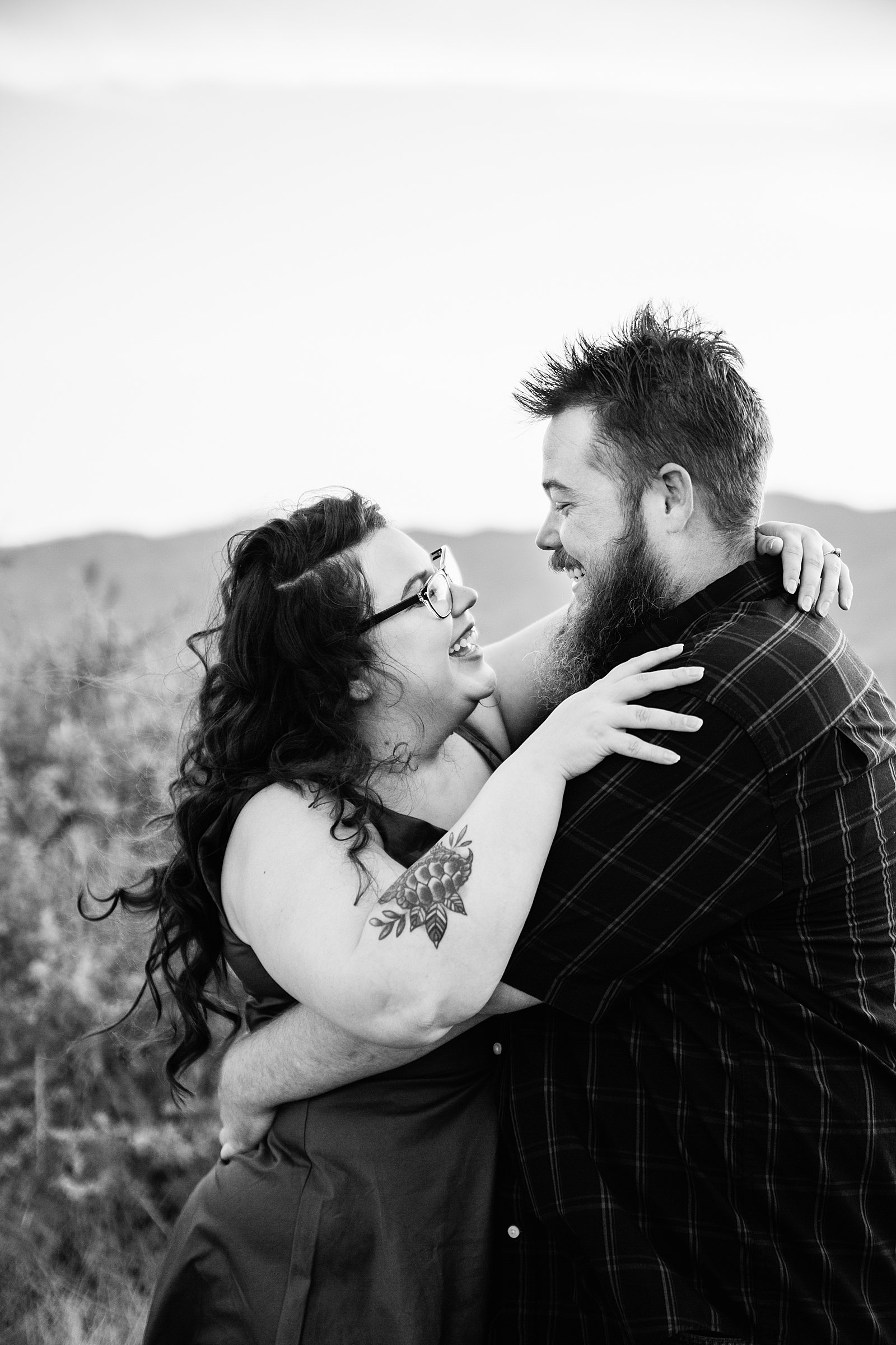Couple laugh together during their Sunset Point engagement session by Phoenix engagement photographer PMA Photography.