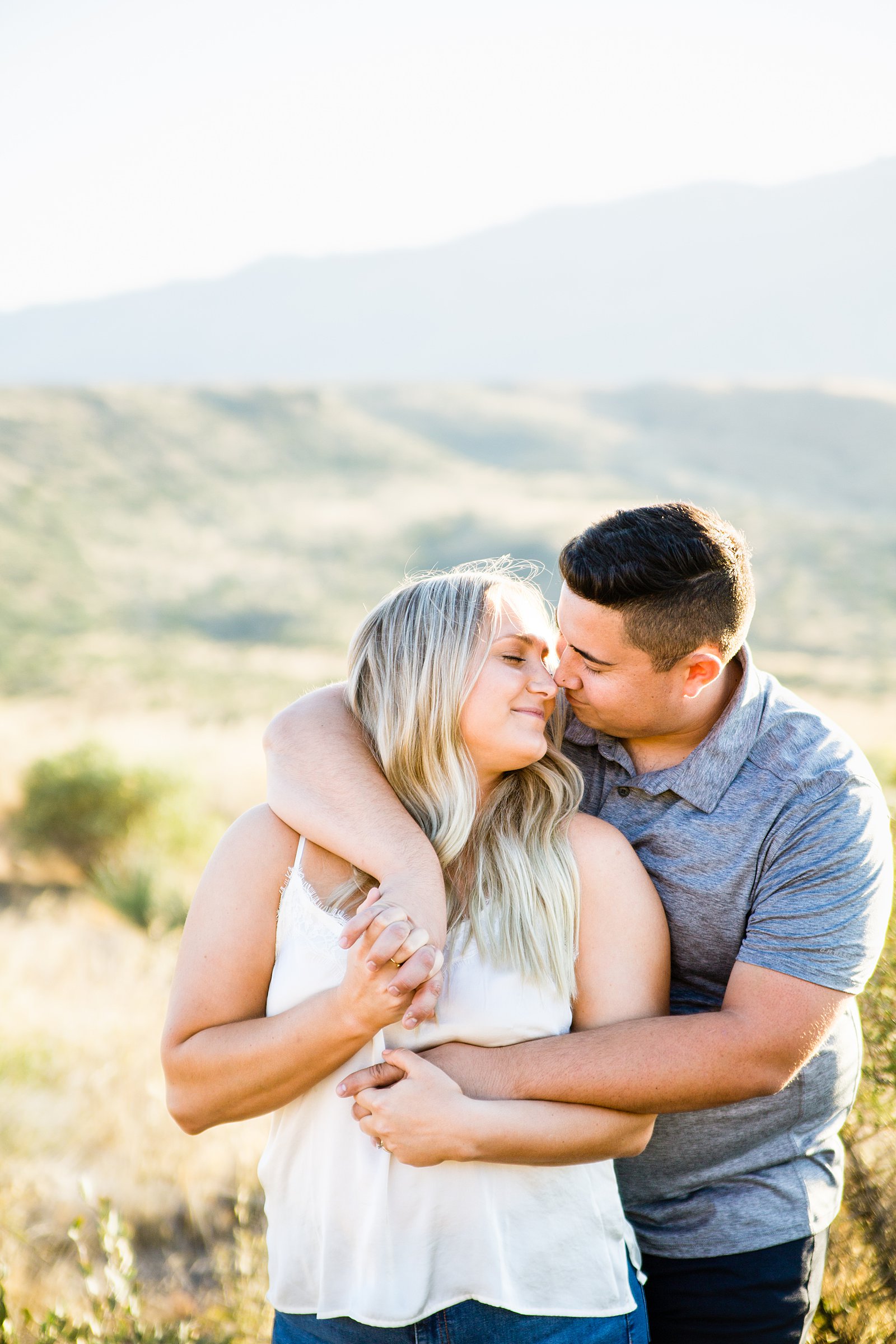 Couple share an intimate moment during their Sunset Point engagement session by Phoenix engagement photographer PMA Photography.