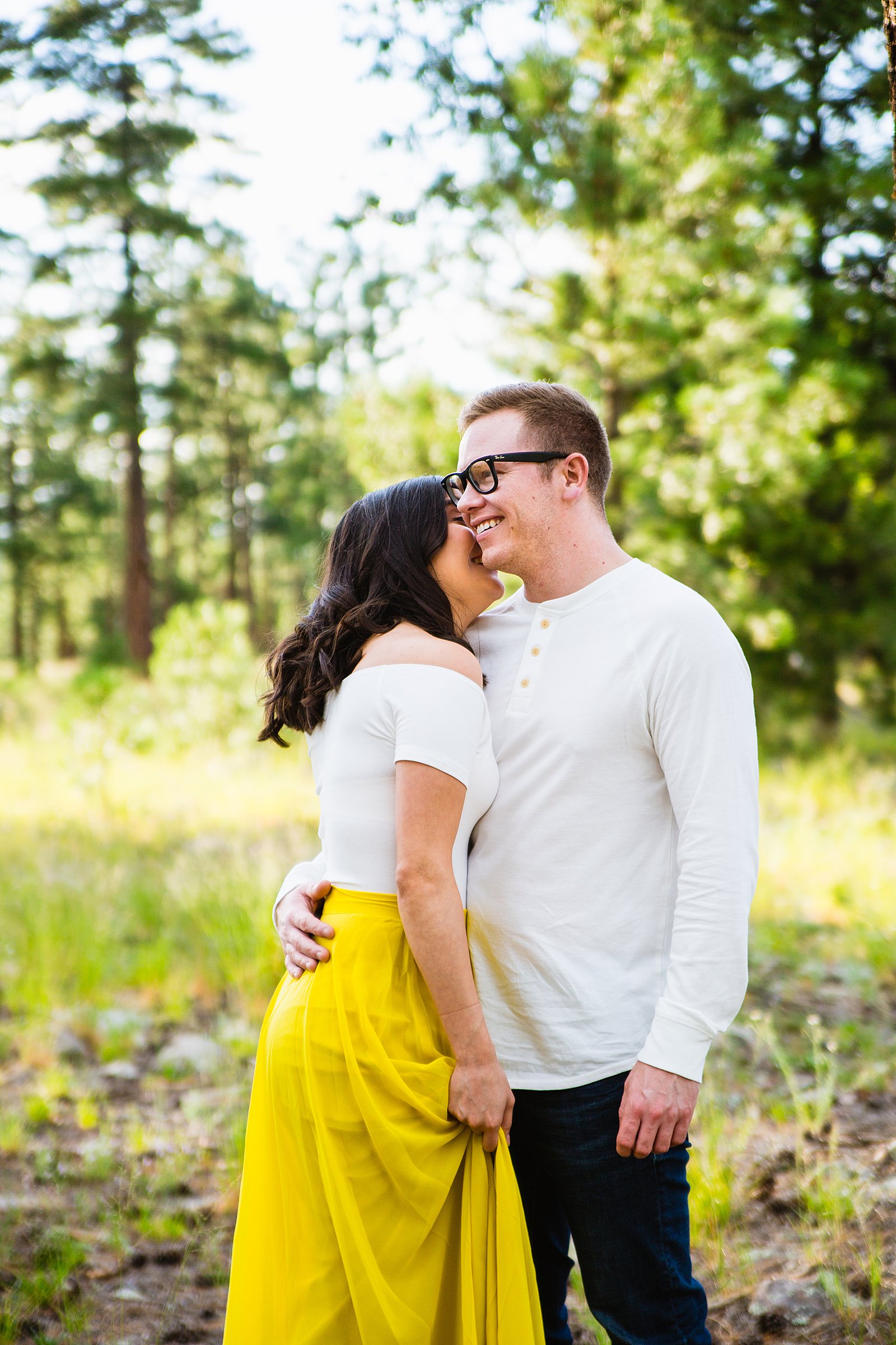 Couple laugh together during their Payson engagement session by Arizona engagement photographer PMA Photography.