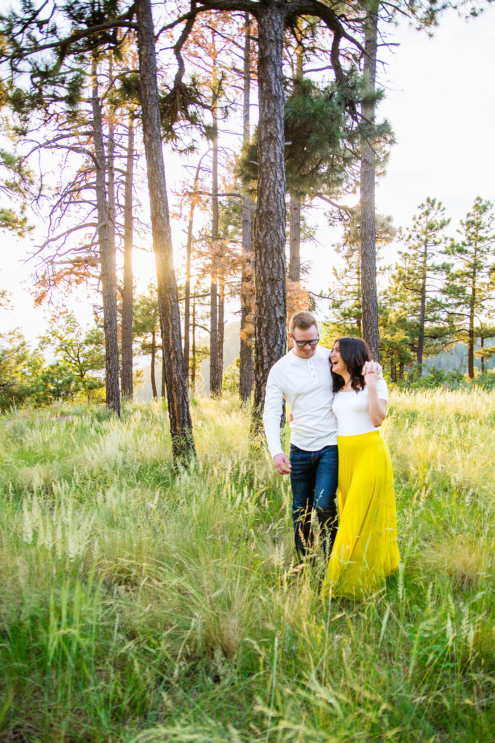 Couple laugh together during their Mogollon Rim engagement session by Payson engagement photographer PMA Photography.