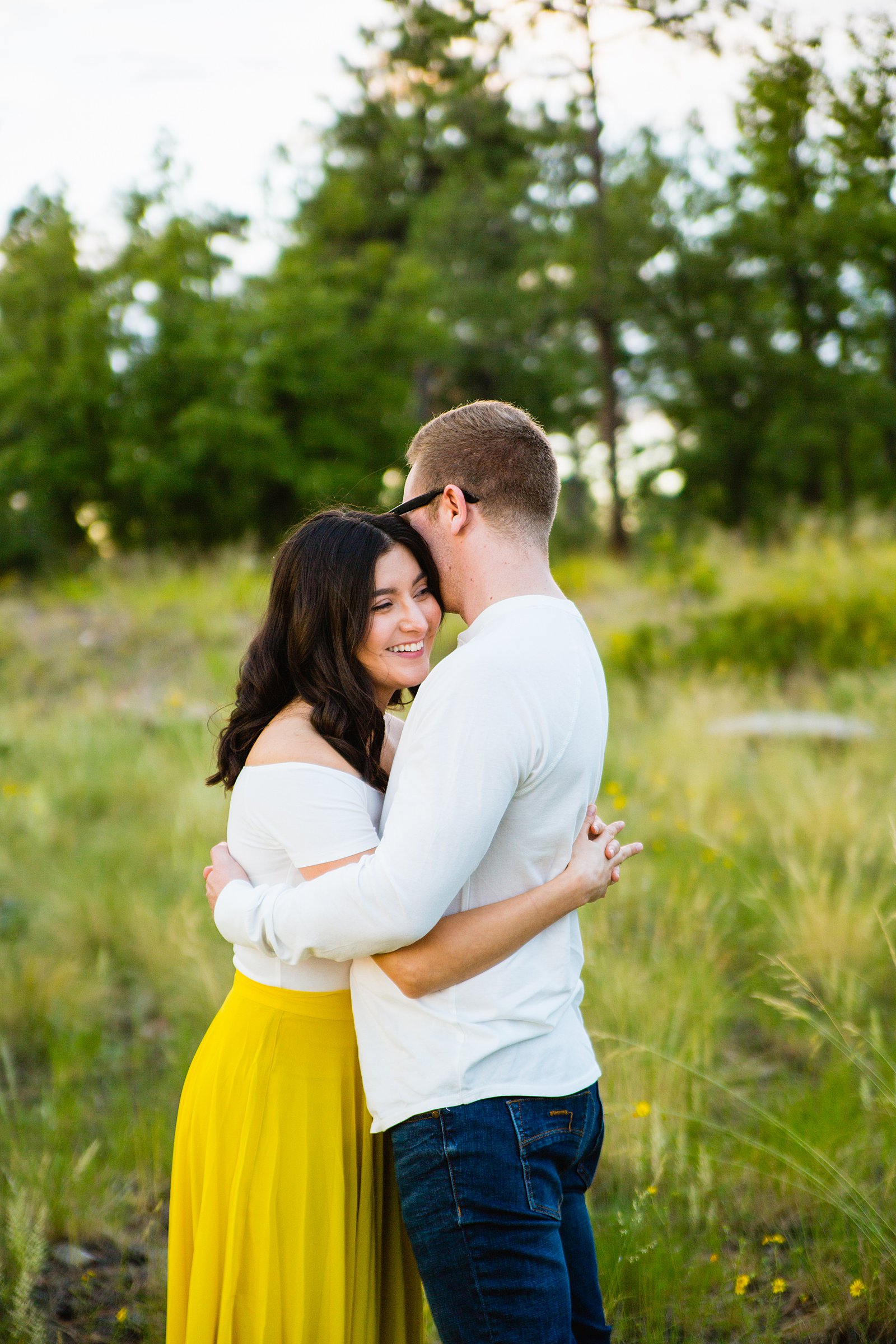 Couple laugh together during their Mogollon Rim engagement session by Payson engagement photographer PMA Photography.